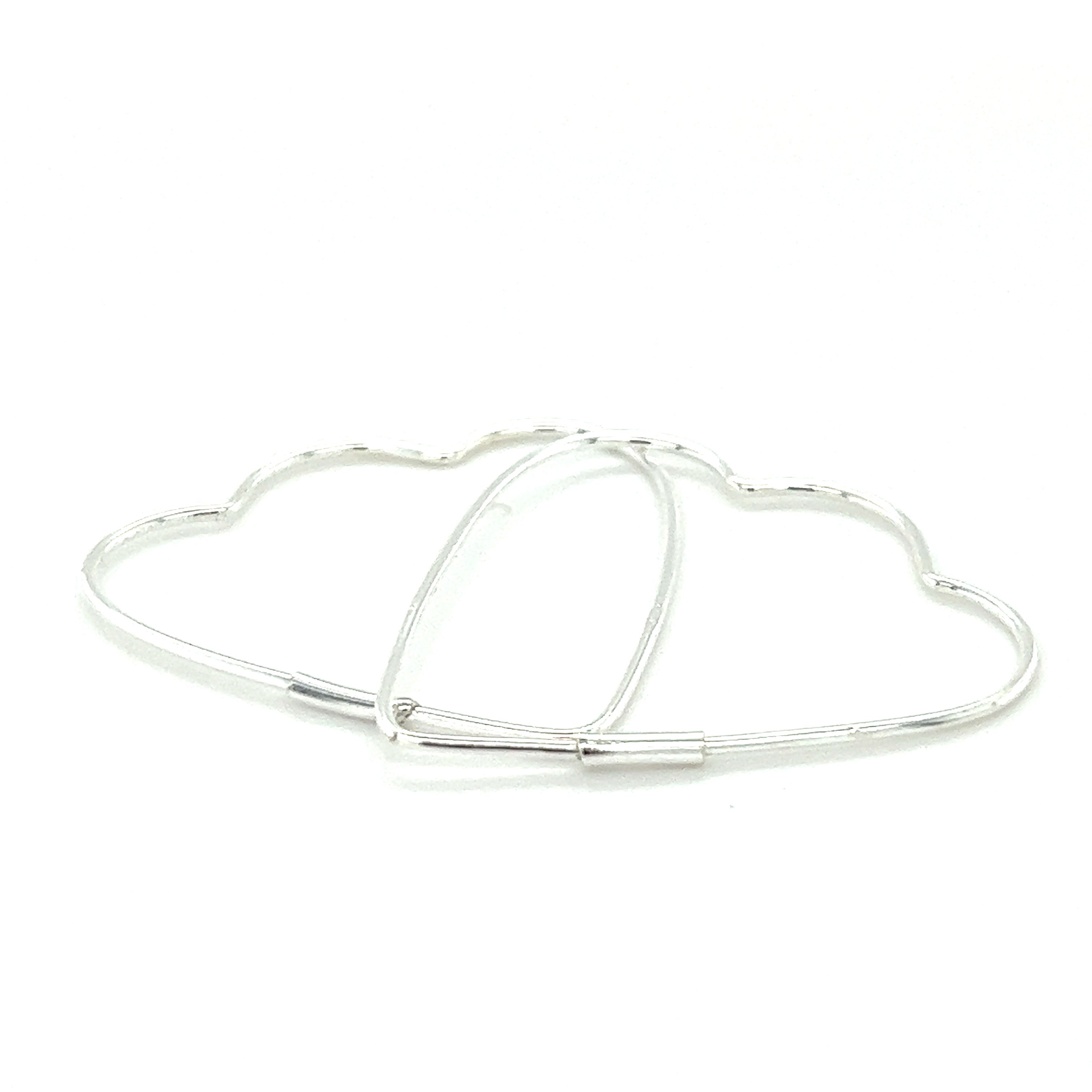 A pair of Delicate Heart Shaped Hoops by Super Silver on a white surface.