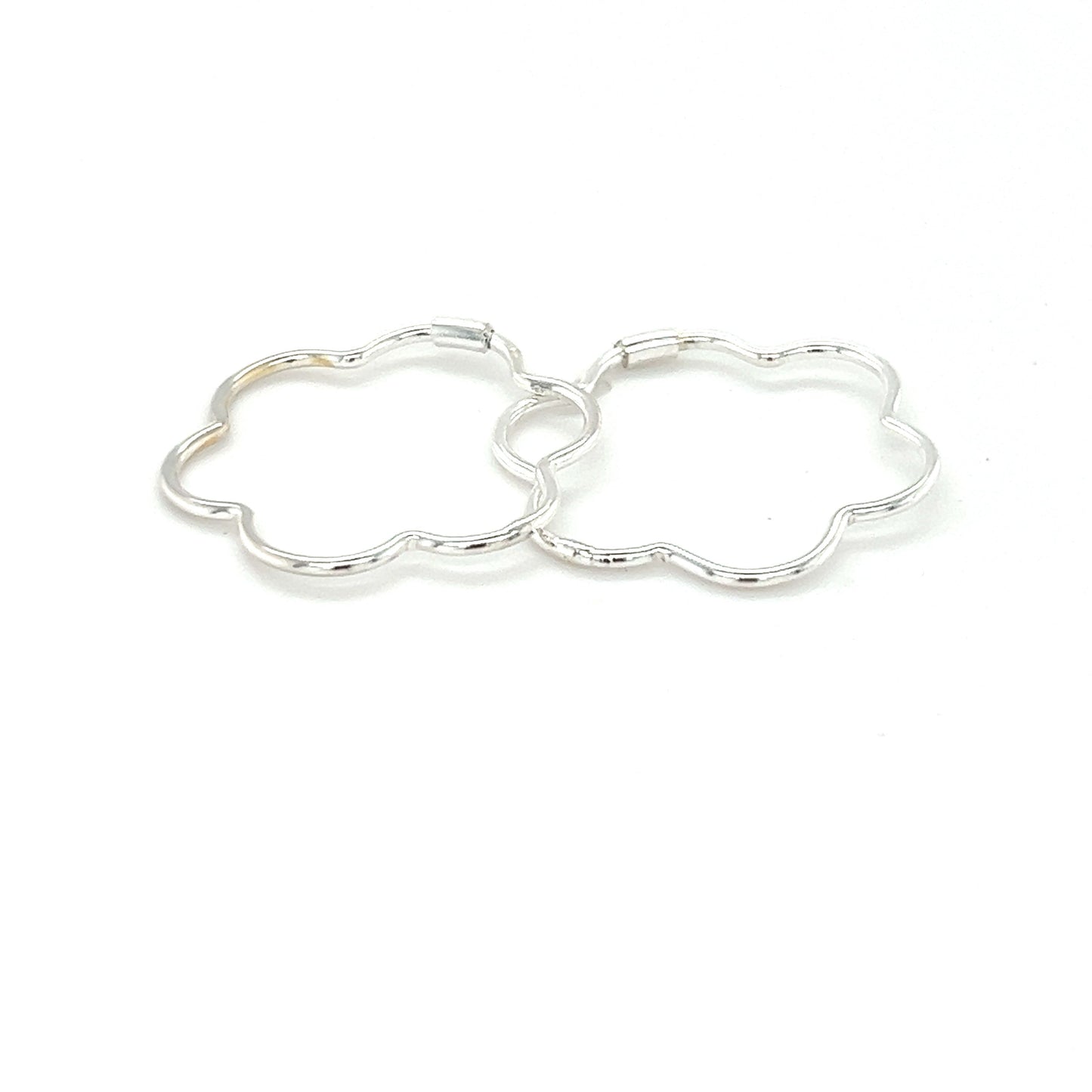 
                  
                    A minimalist pair of Super Silver delicate flower shaped hoops on a white background.
                  
                