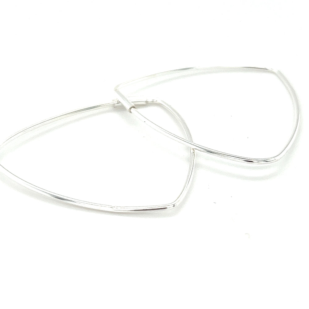 
                  
                    A pair of Delicate Triangle Shaped Hoops by Super Silver on a white background.
                  
                