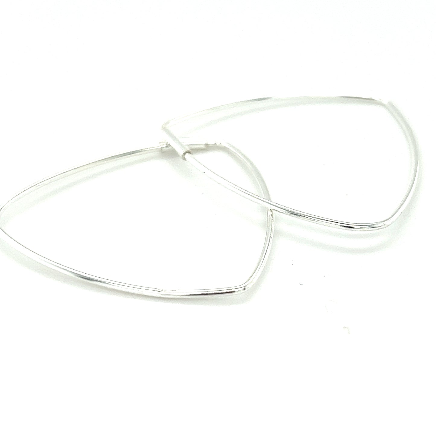 
                  
                    A pair of Super Silver Delicate Triangle Shaped Hoops on a white surface.
                  
                