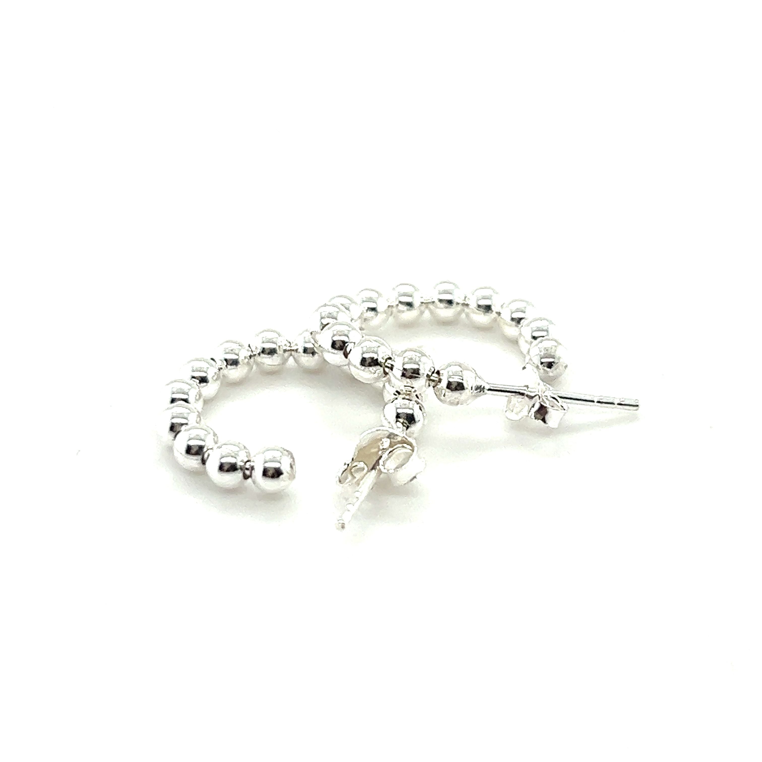 A pair of Super Silver Delicate Ball Hoops With Post on a white background, featuring a minimalist design.