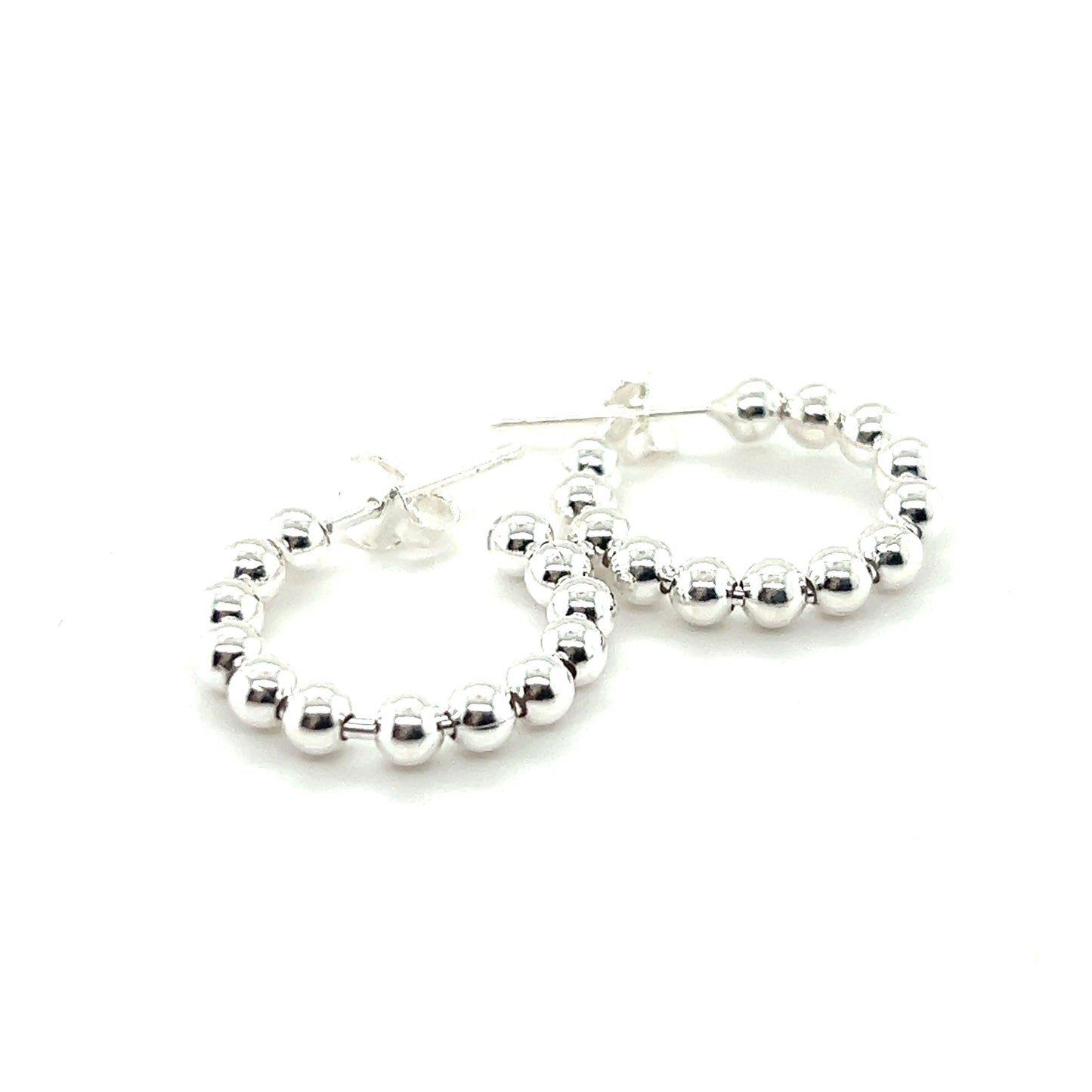 
                  
                    A pair of Super Silver Delicate Ball Hoops With Post earrings on a white background.
                  
                