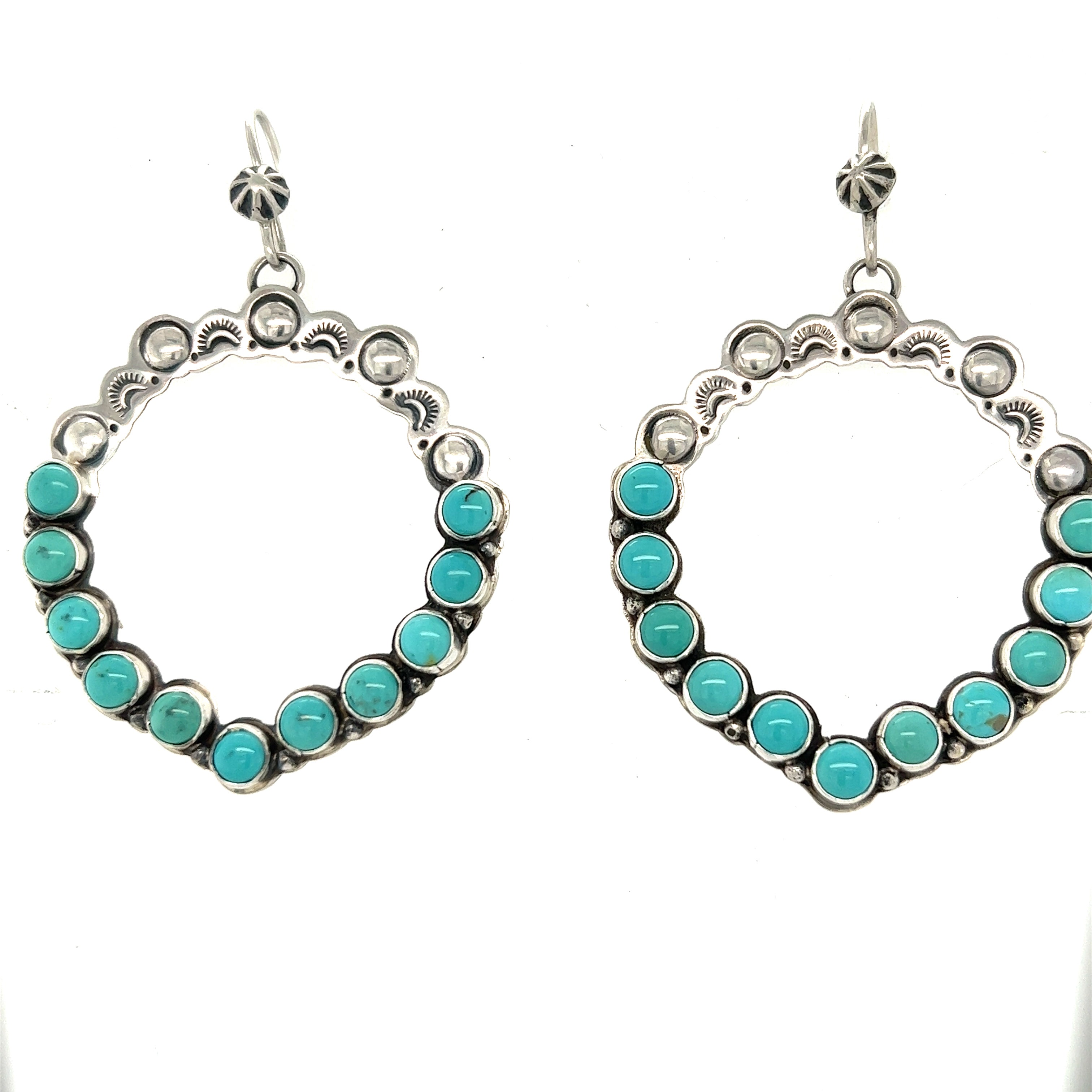 Super Silver's statement handmade turquoise earrings add southwestern elegance.