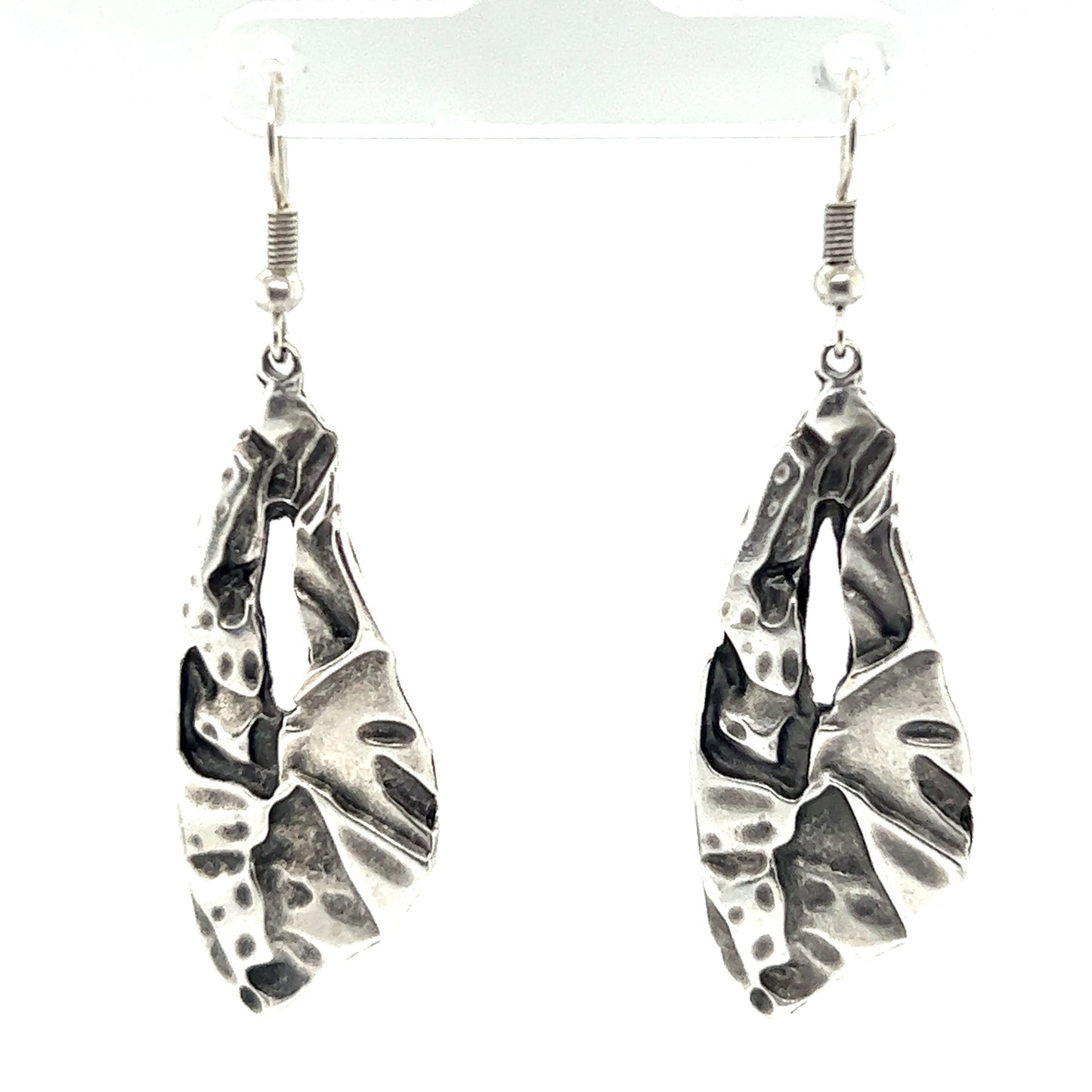 
                  
                    A pair of trendy and boho-chic Triangular Boho Statement Earrings adorned with leaves, making them the perfect urban boho jewelry accessory.
                  
                