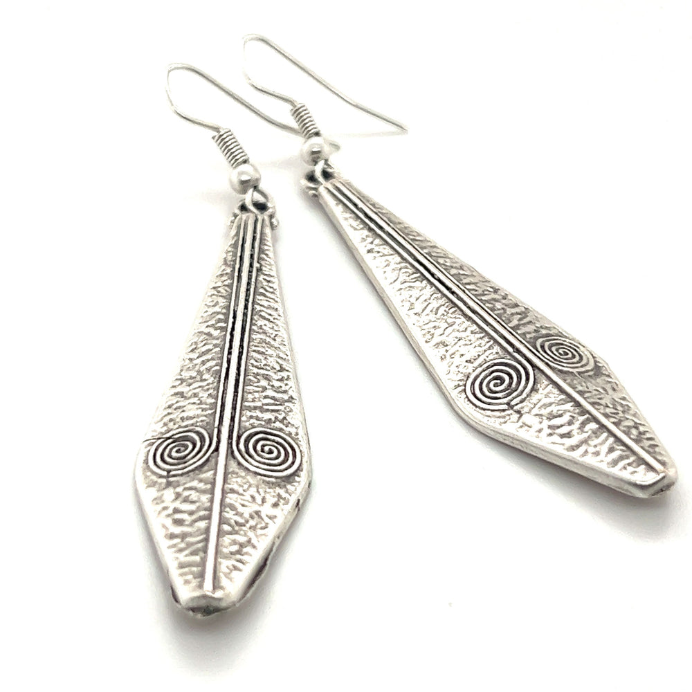 
                  
                    A pair of Triangular Boho Statement Earrings by Super Silver, with intricate designs, crafted from Zamak.
                  
                
