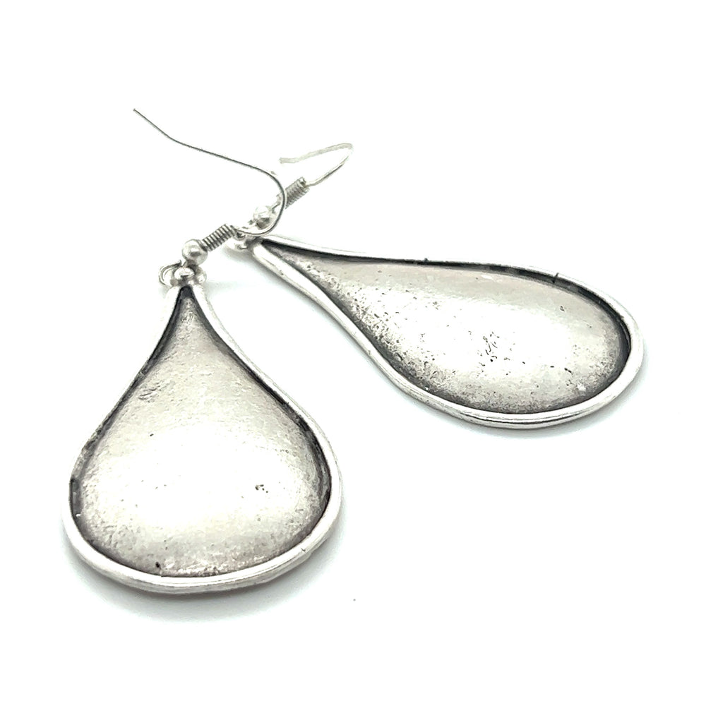
                  
                    A pair of Super Silver Long Boho Statement Earrings on a white background, making for a dramatic accessory.
                  
                