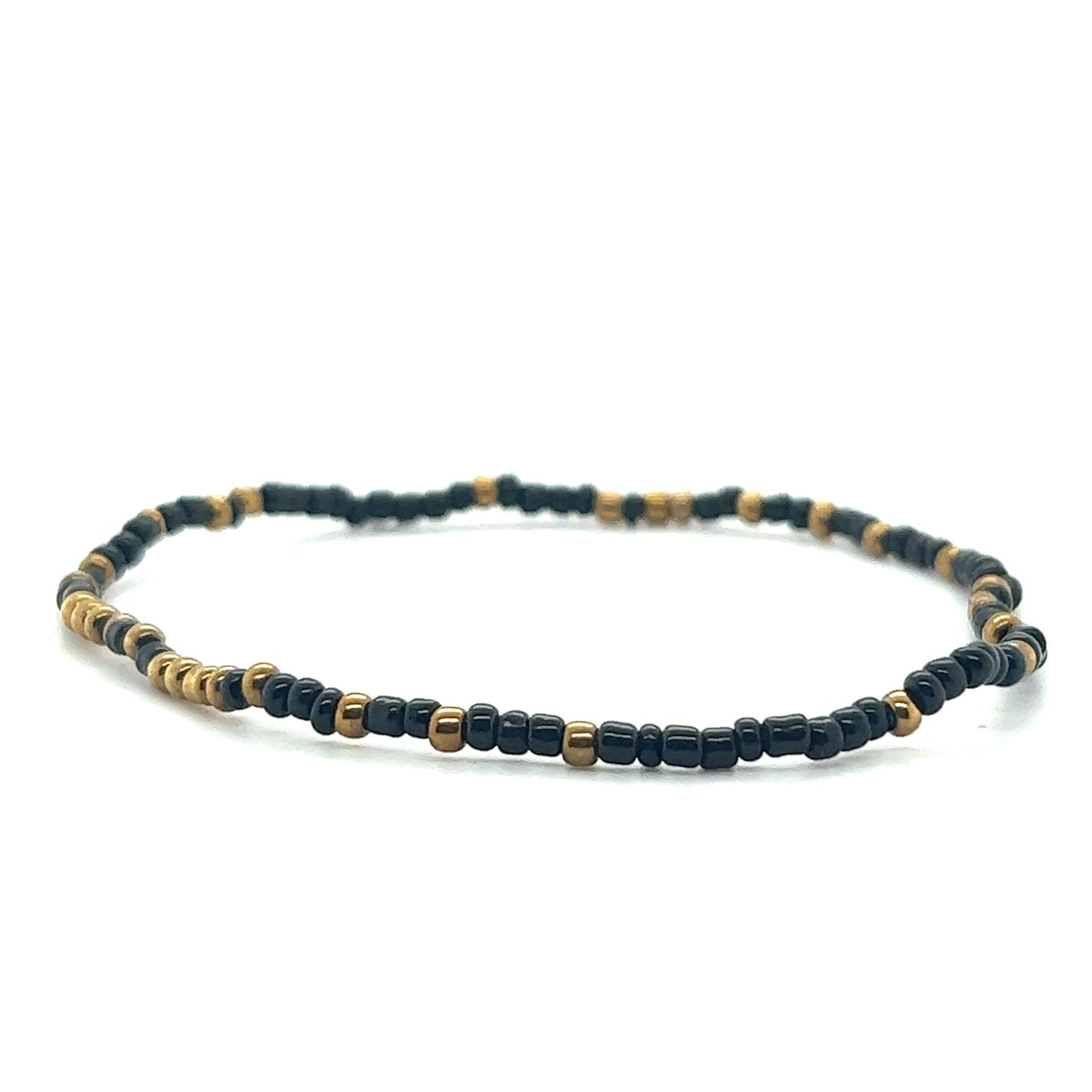 
                  
                    A black and gold Dainty Beaded Bracelet by Super Silver on a white background.
                  
                