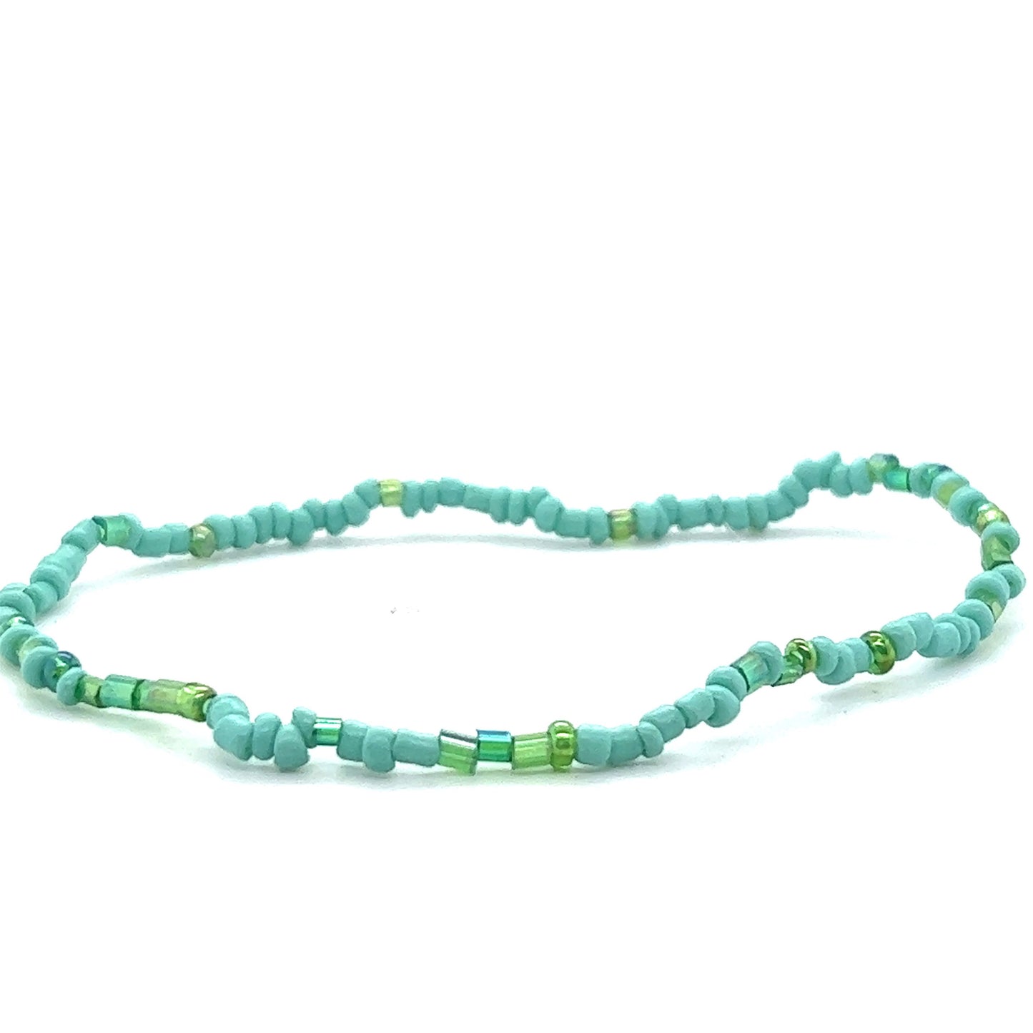 
                  
                    A Dainty Beaded Bracelet in turquoise and green colors on a white background by Super Silver.
                  
                