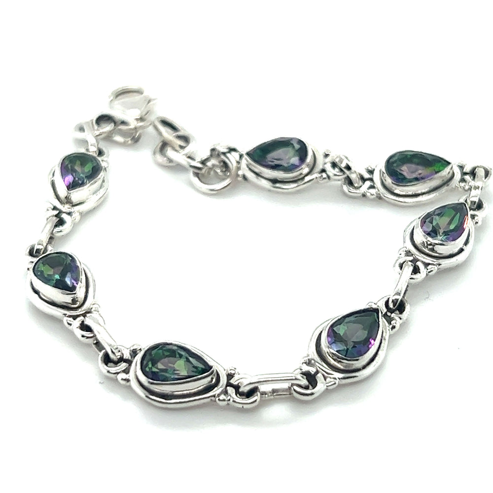 
                  
                    A Super Silver Rainbow Topaz Teardrop Bracelet, with green and purple stones, featuring a mesmerizing combination of Rainbow Topaz and Mystic Topaz.
                  
                