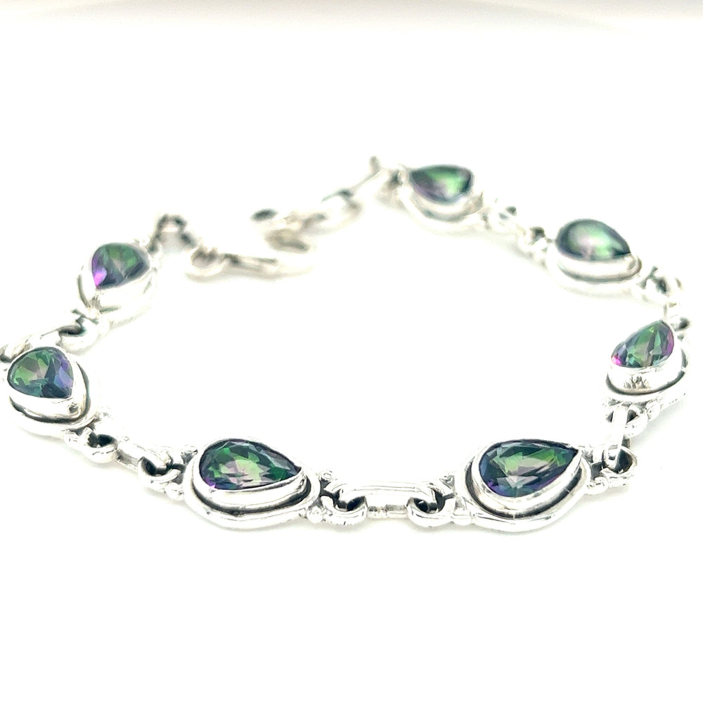 
                  
                    A Super Silver Rainbow Topaz Teardrop Bracelet embellished with green and purple stones.
                  
                