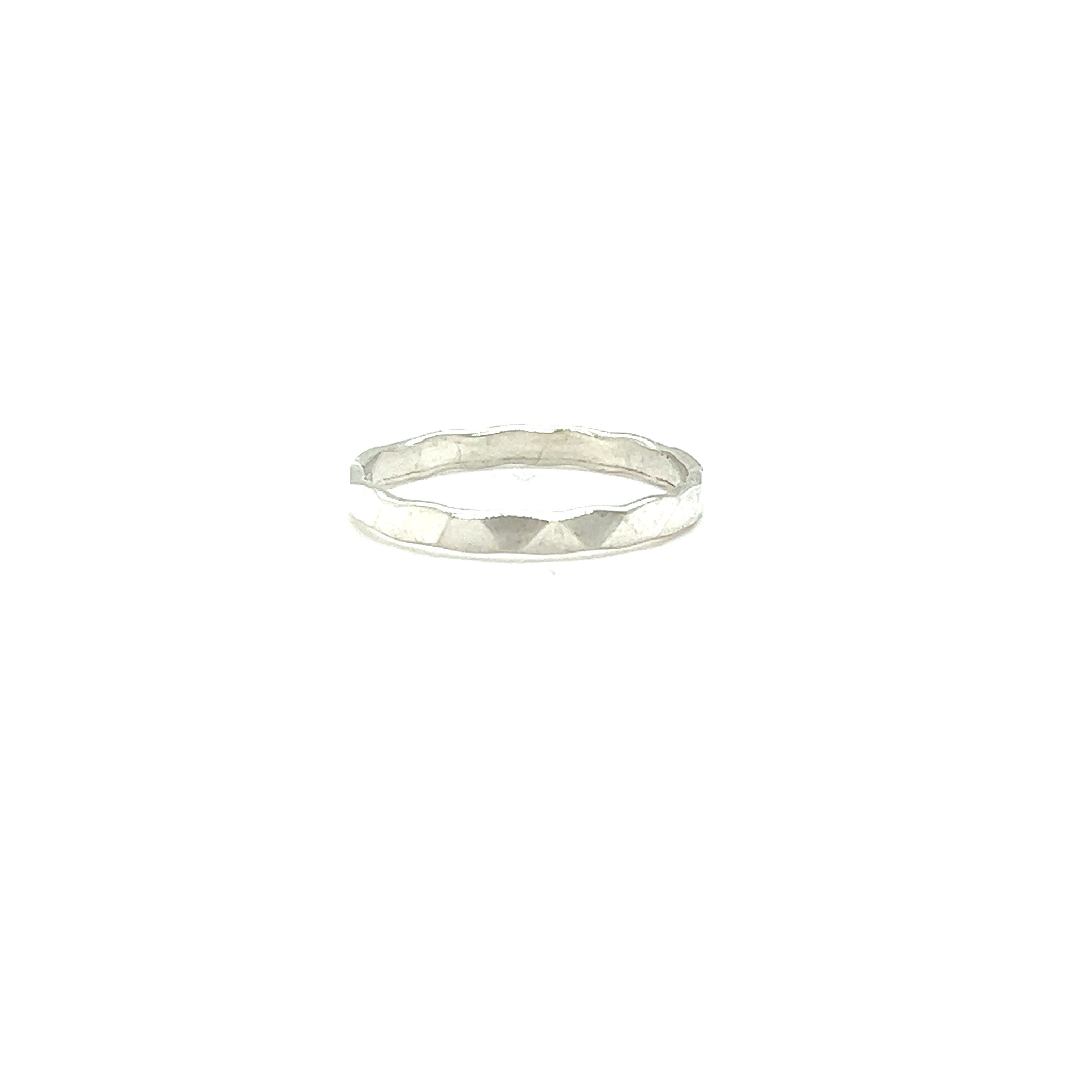 A Diamond Cut Minimalist Silver Band with a diamond in the middle.