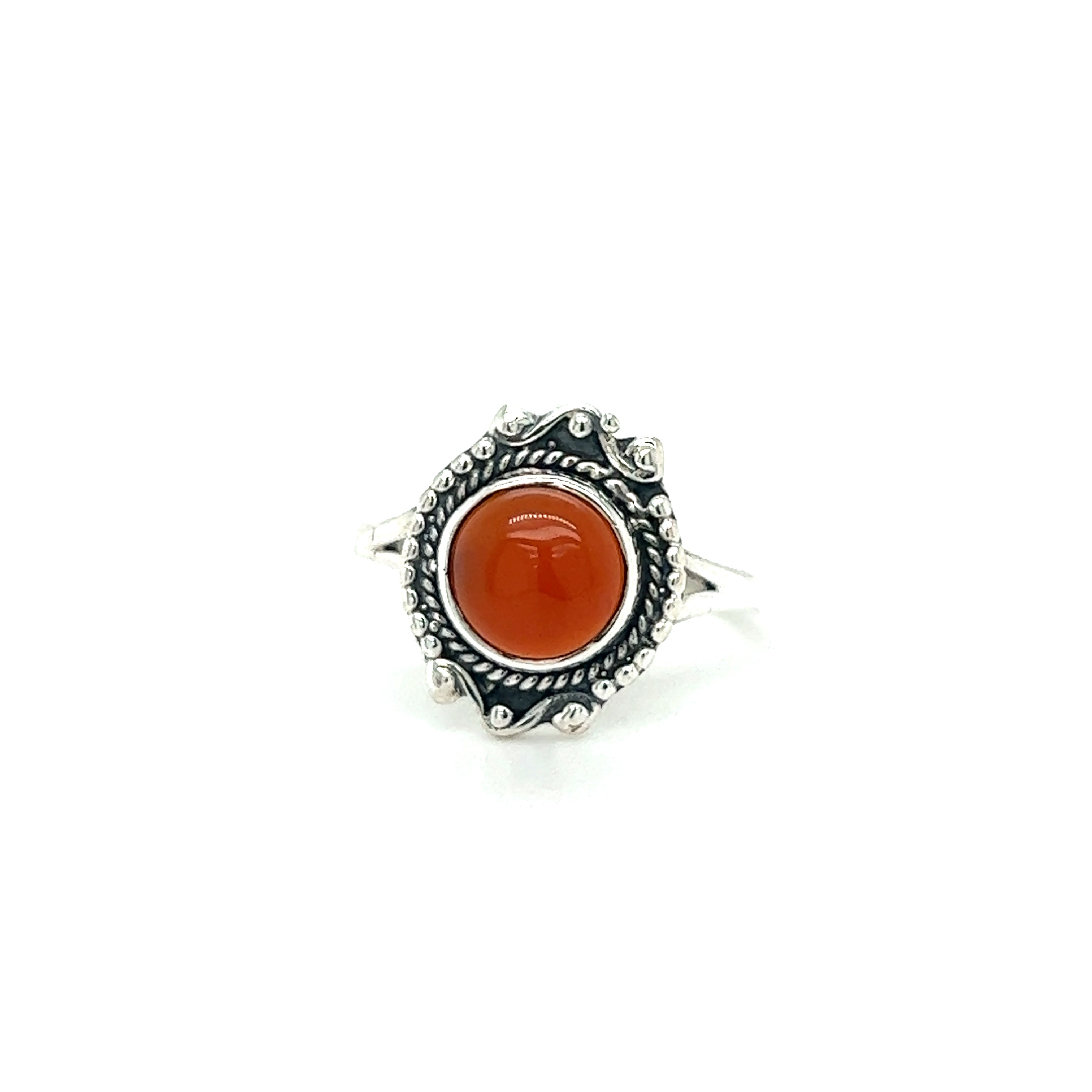 A round gemstone ring with vintage setting adorned with a vibrant orange stone.
