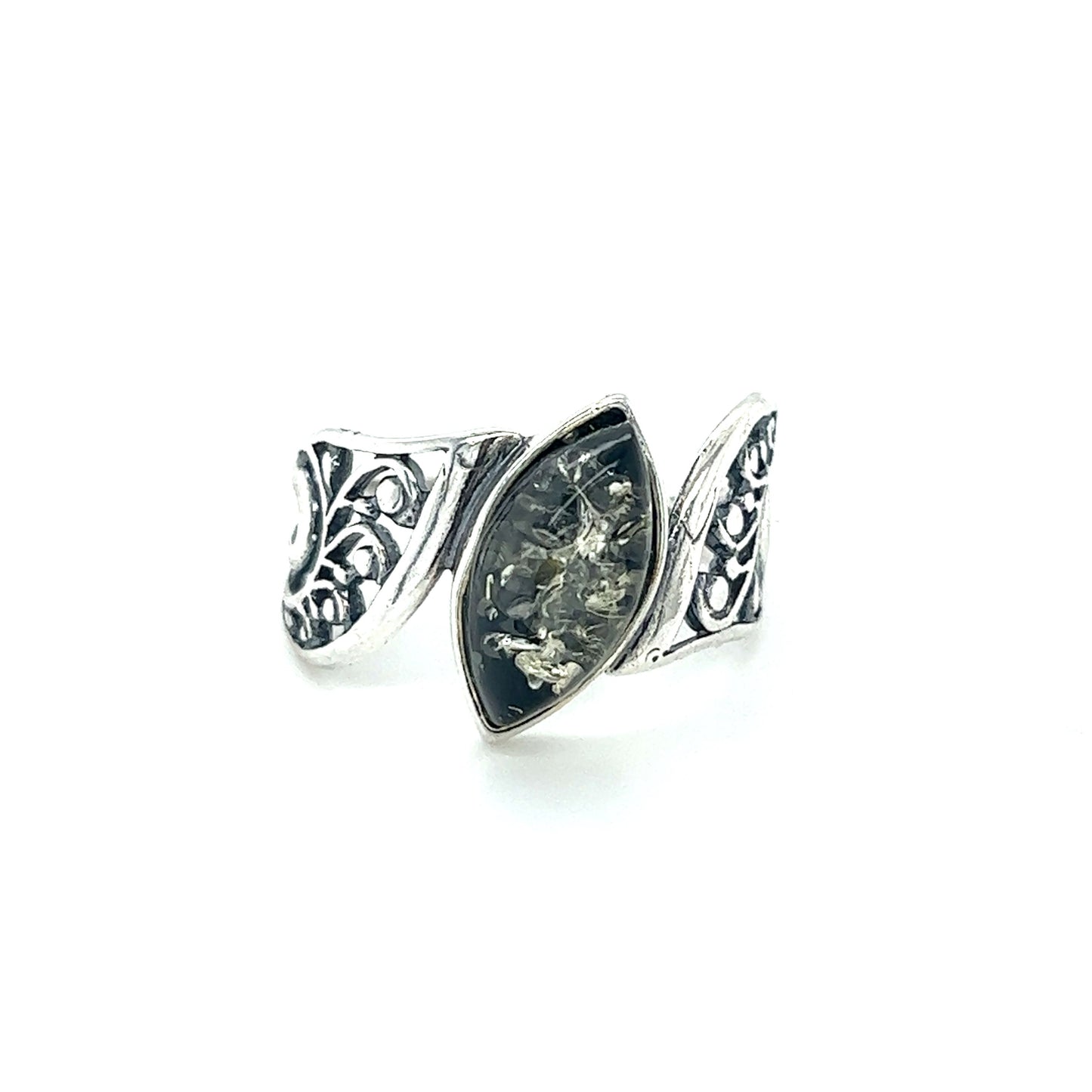 
                  
                    A Super Silver Wide Filigree Band Baltic Amber Ring with an ornate design.
                  
                