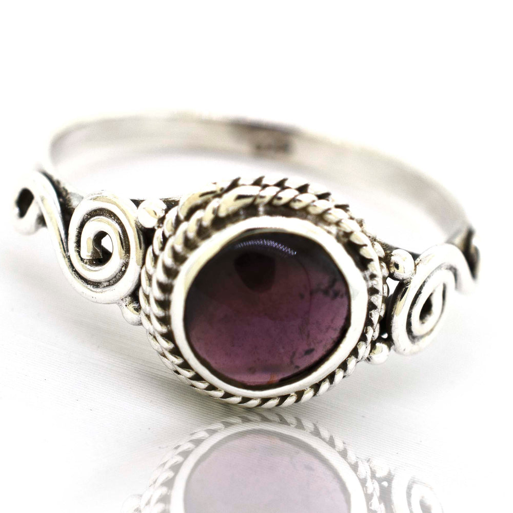 
                  
                    A bohemian-inspired Super Silver Gemstone Circle Ring With Rope Border And Swirl Design with a beautiful purple Gemstone Circle Ring With Rope Border And Swirl Design set in .925 sterling silver.
                  
                