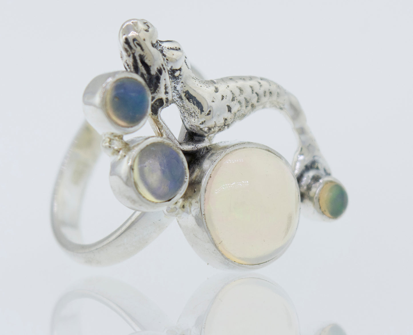 A mythical Mermaid Ring with Ethiopian Opal adorned with a mesmerizing mermaid and captivating Ethiopian opals.
