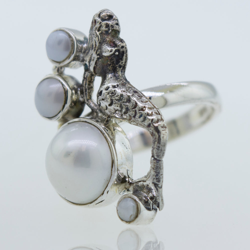 
                  
                    A mythical Mermaid Ring with Pearl, crafted in sterling silver.
                  
                