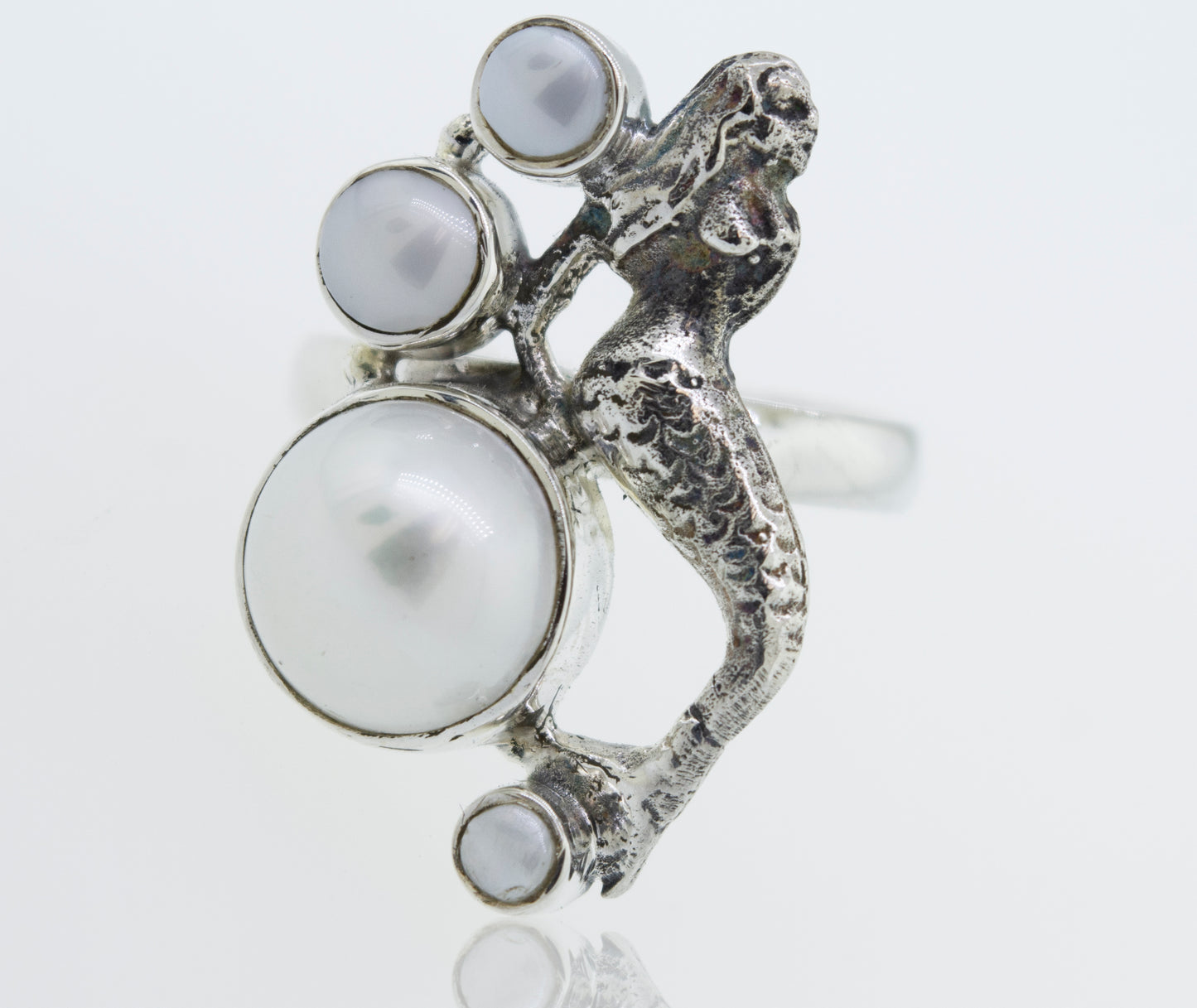 
                  
                    A Mermaid Ring with Pearl adorned with a mermaid and pearls, inspired by the enchanting depths of the ocean.
                  
                