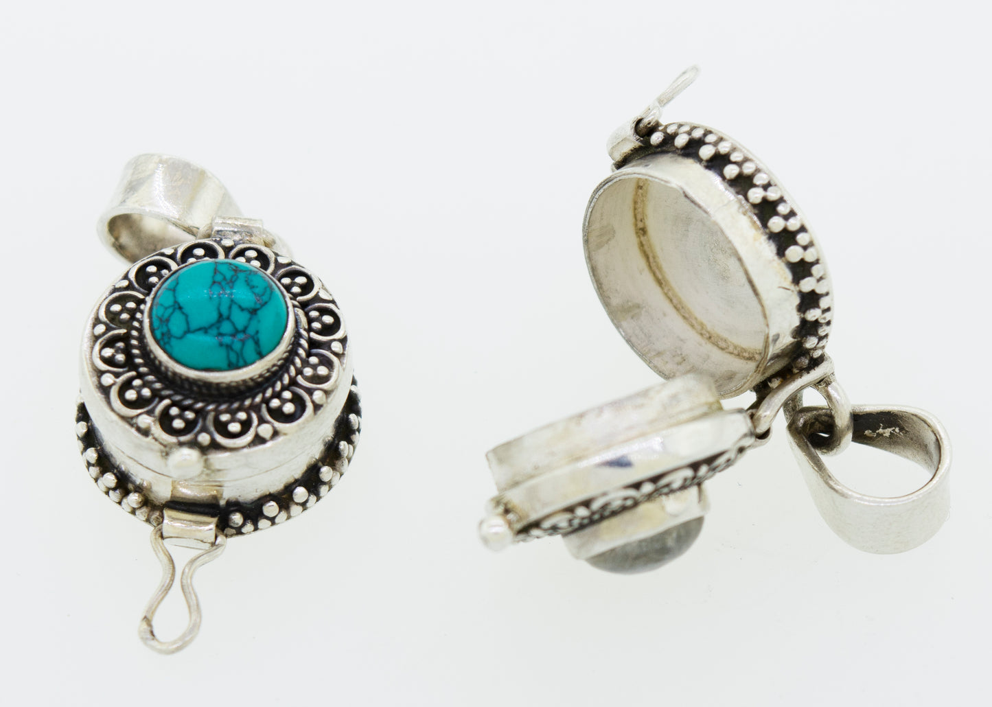 
                  
                    A pair of silver Stone Poison Locket pendants featuring turquoise stones from Super Silver.
                  
                