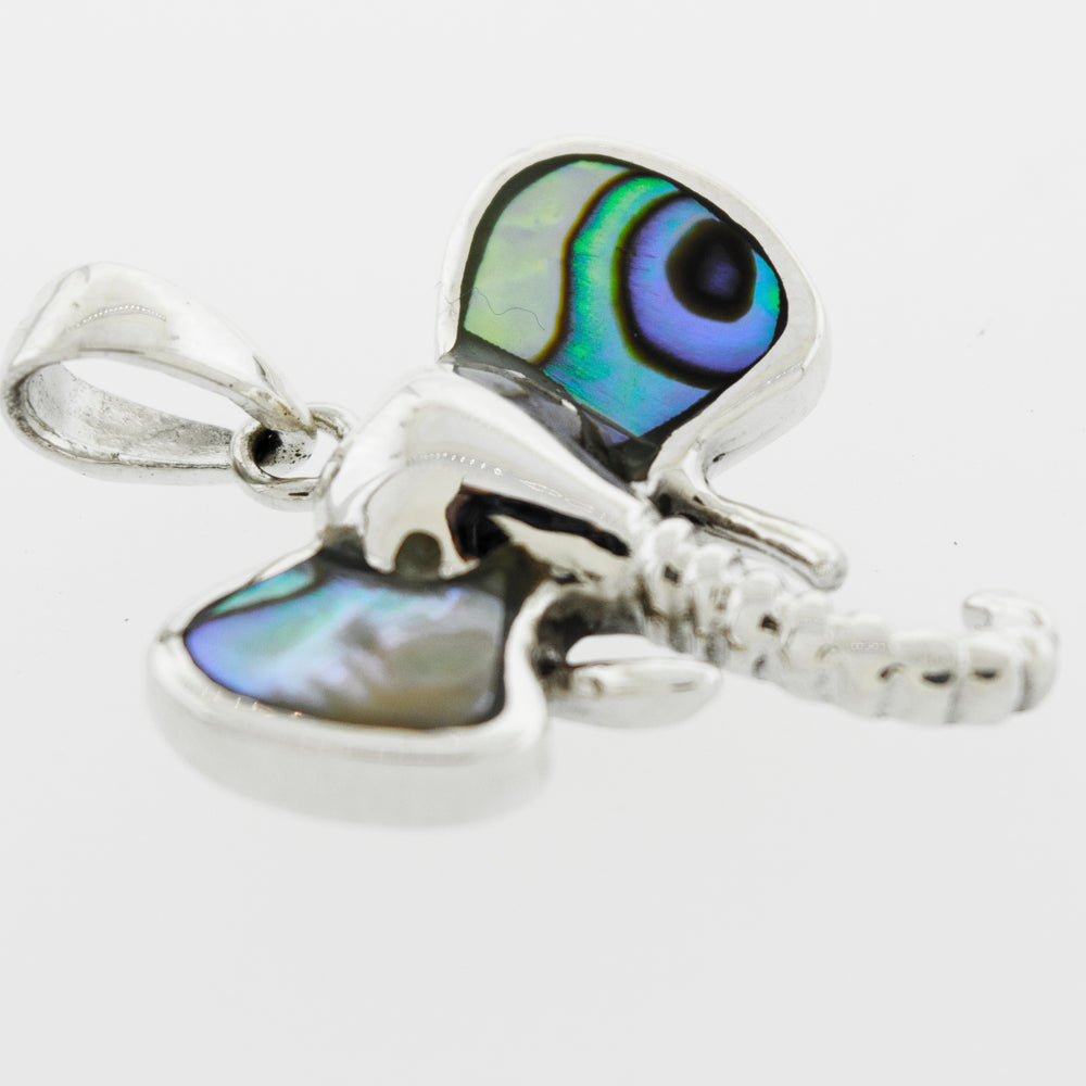 A Super Silver elephant head pendant with inlaid stone ears and blue and green eyes.