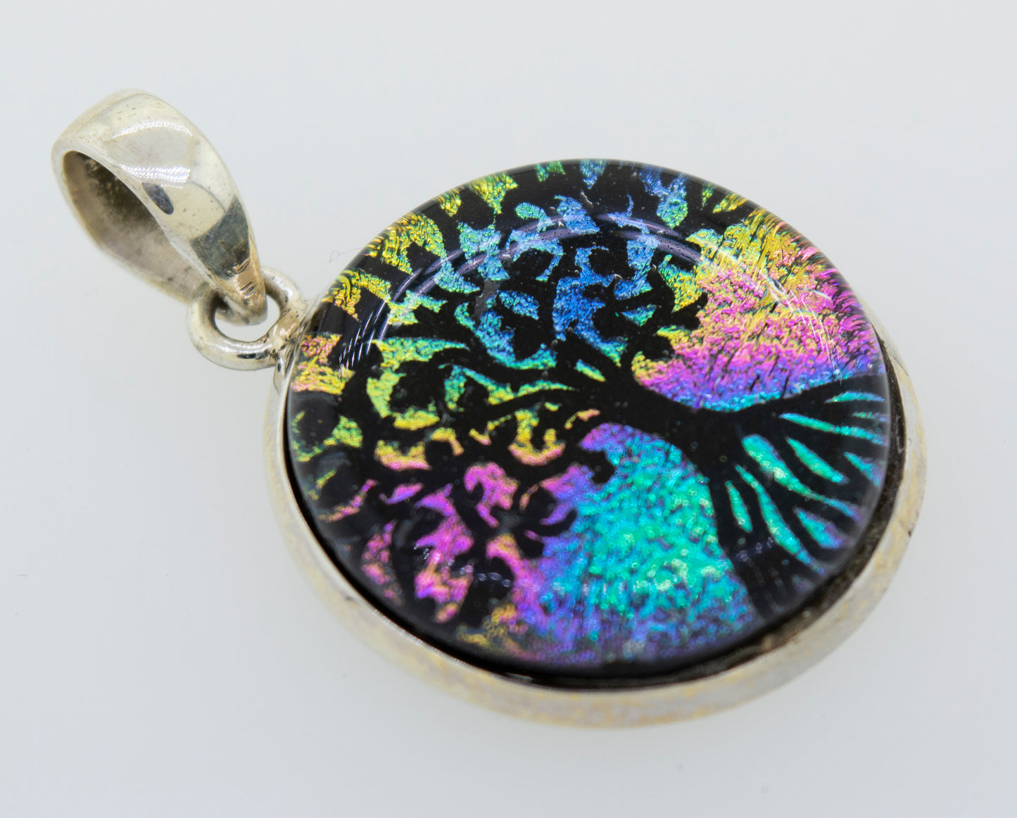 A colorful Dichroic Glass Tree Of Life pendant crafted from Super Silver.