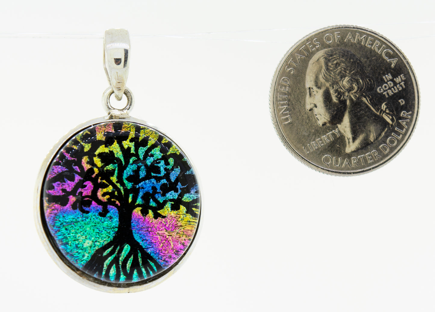 
                  
                    A vibrant Super Silver Dichroic Glass Tree of Life pendant, elegantly showcased next to a dime.
                  
                
