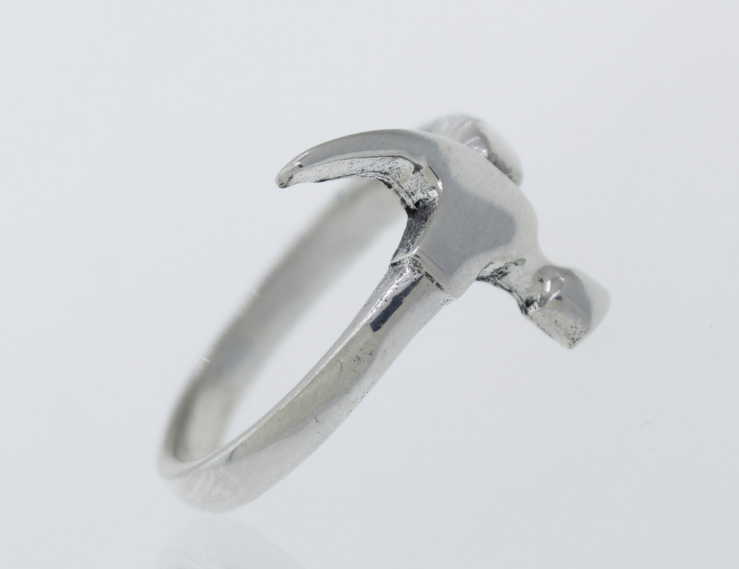 A Super Silver hammer ring on a white surface.