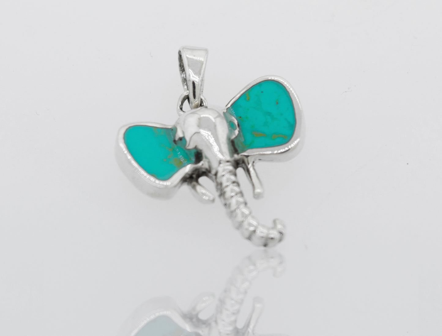
                  
                    A Super Silver Elephant Head Pendant with inlaid turquoise stone ears.
                  
                