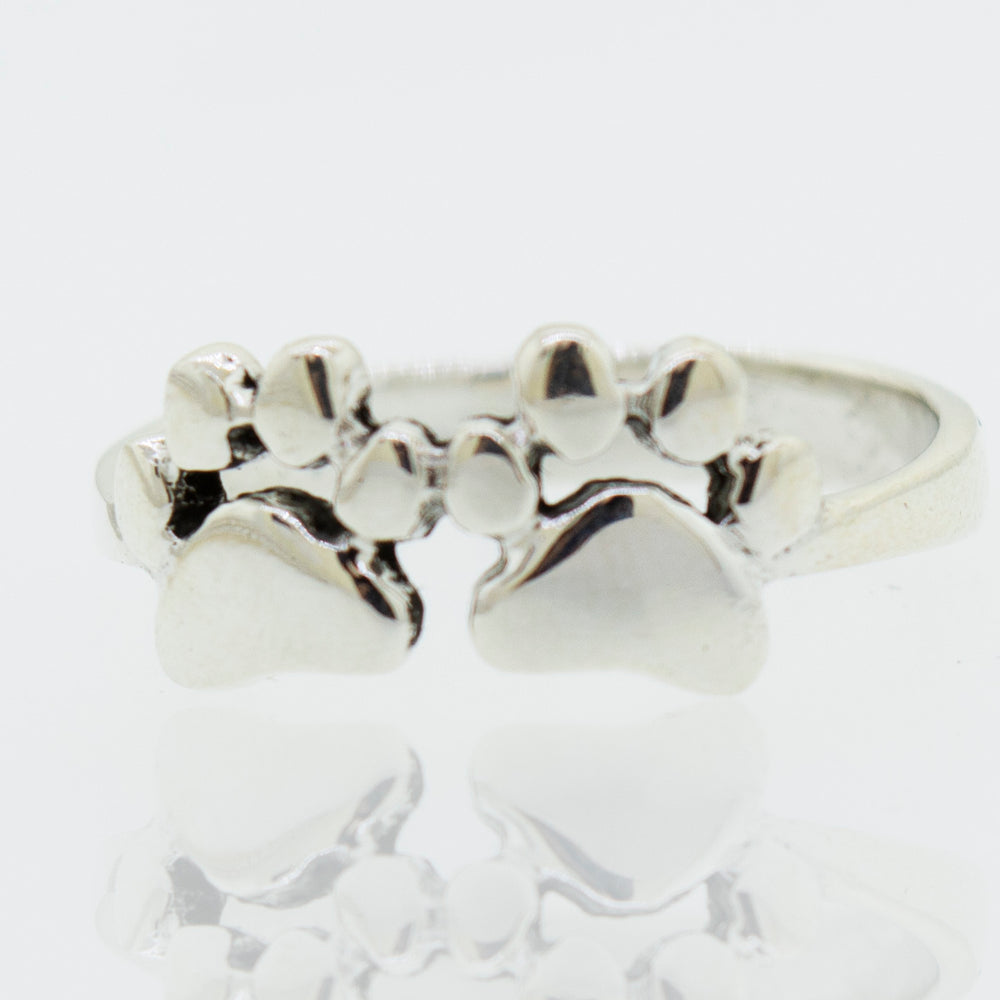 A Super Silver Paw Print Ring adorned with two paw prints.