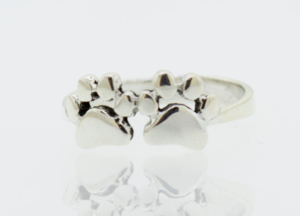 A Super Silver Paw Print Ring adorned with two paw prints.