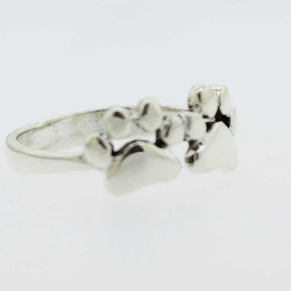 
                  
                    A Super Silver Paw Print Ring adorned with delicate paw prints gleaming on its surface.
                  
                