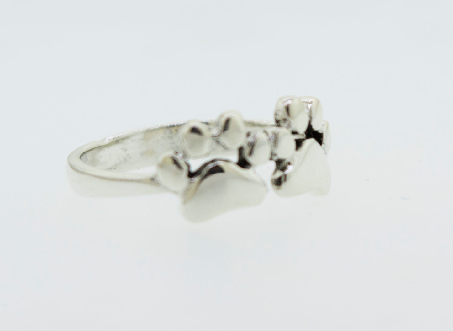 
                  
                    A Super Silver Paw Print Ring adorned with delicate paw prints gleaming on its surface.
                  
                