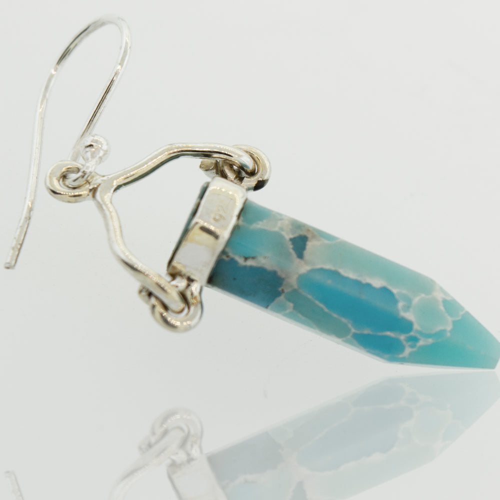 
                  
                    A pair of Super Silver Obelisk Shape Raw Larimar Earrings with French hooks.
                  
                