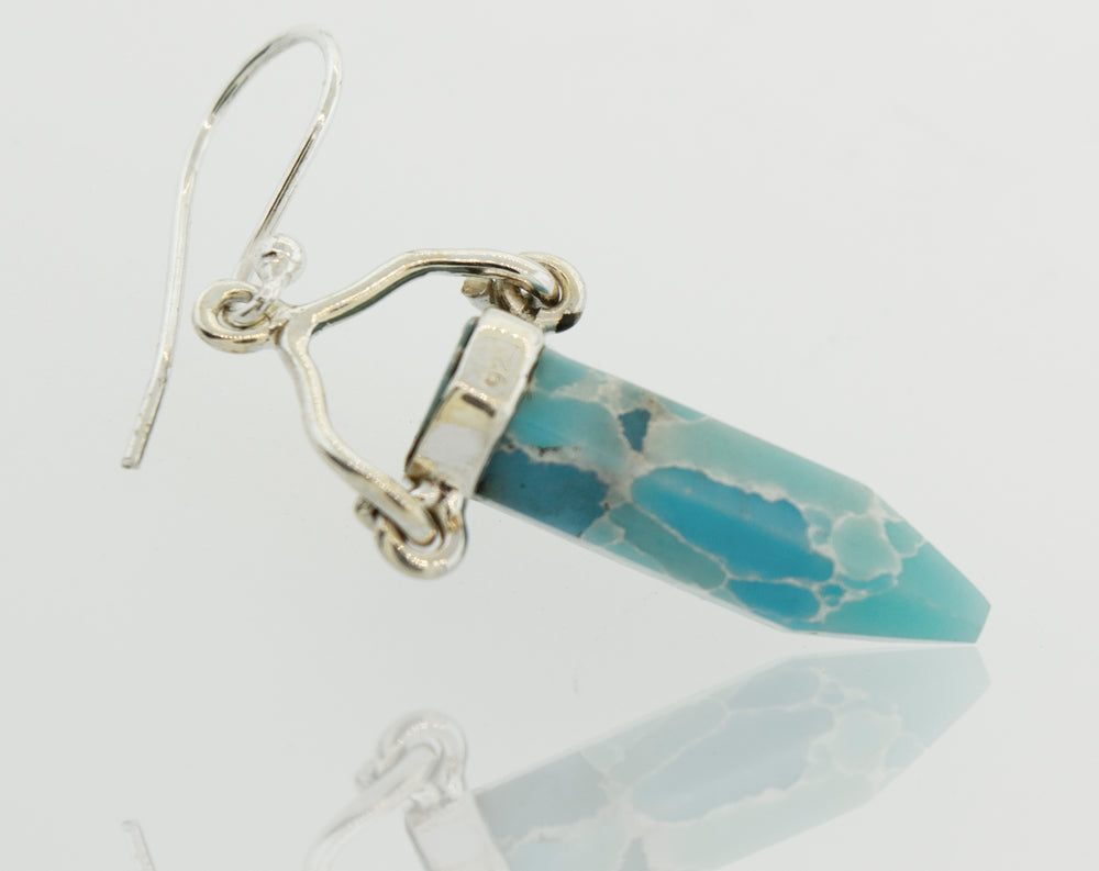 A pair of Super Silver Obelisk Shape Raw Larimar Earrings with French hooks.