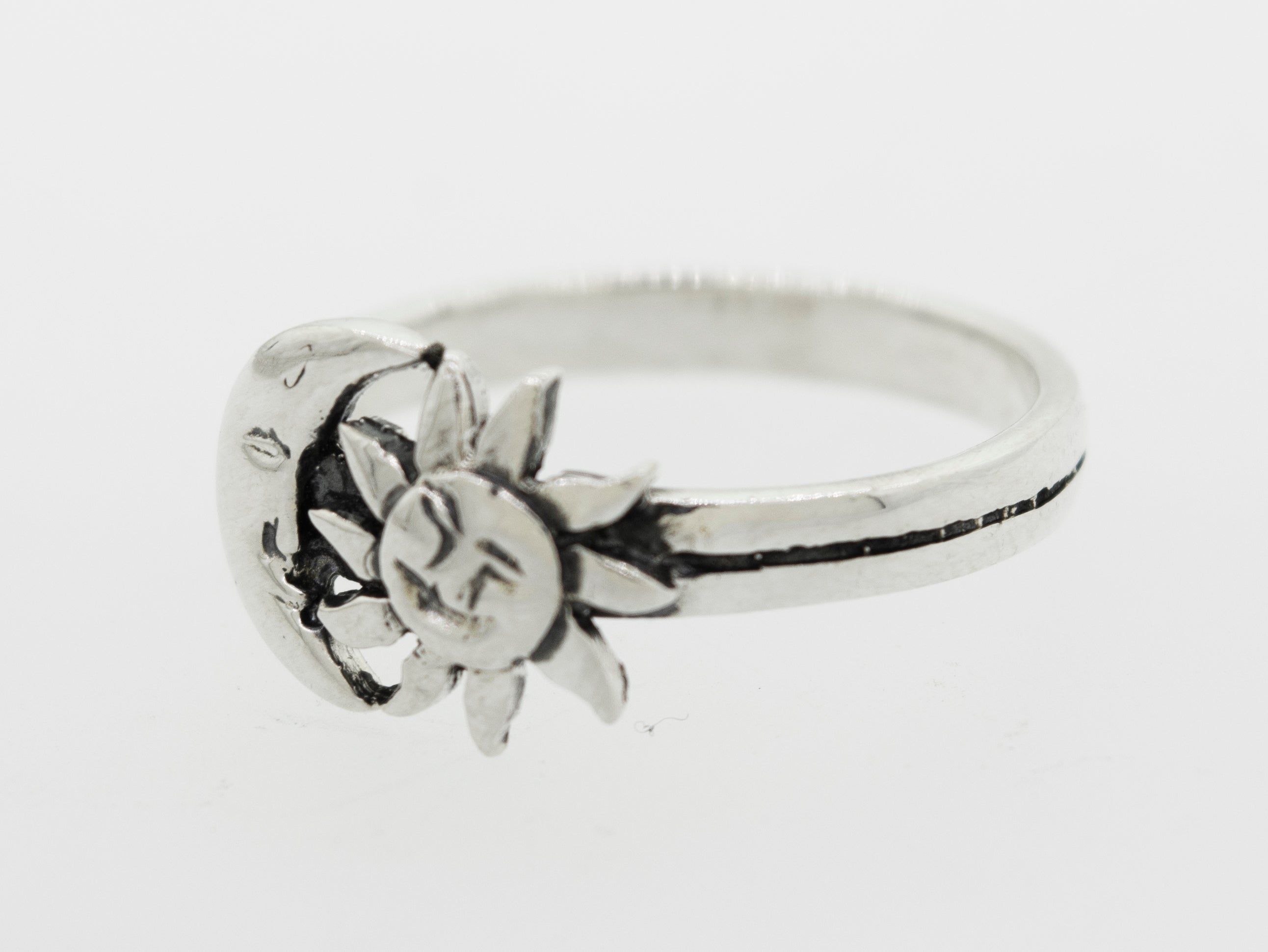 An oxidized Super Silver Moon And Sun With Face Ring.