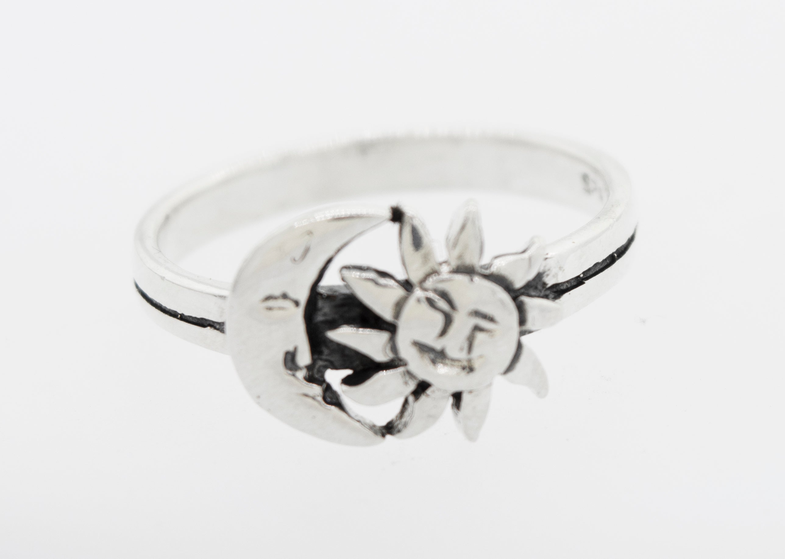 An oxidized Super Silver ring adorned with the delicately designed celestial duo, Moon And Sun With Face.