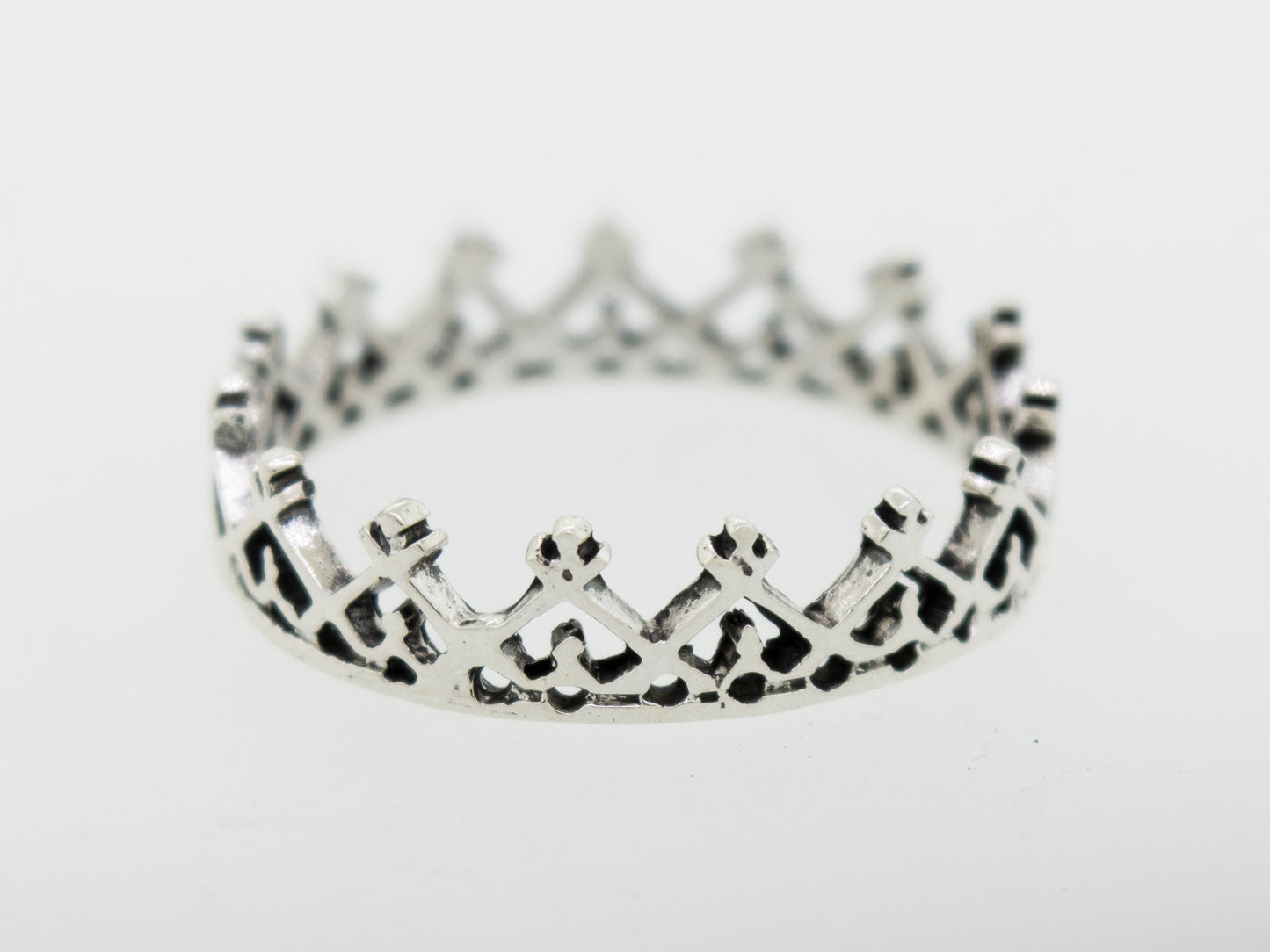 
                  
                    A Super Silver silver crown ring with freestyle design on a white surface.
                  
                