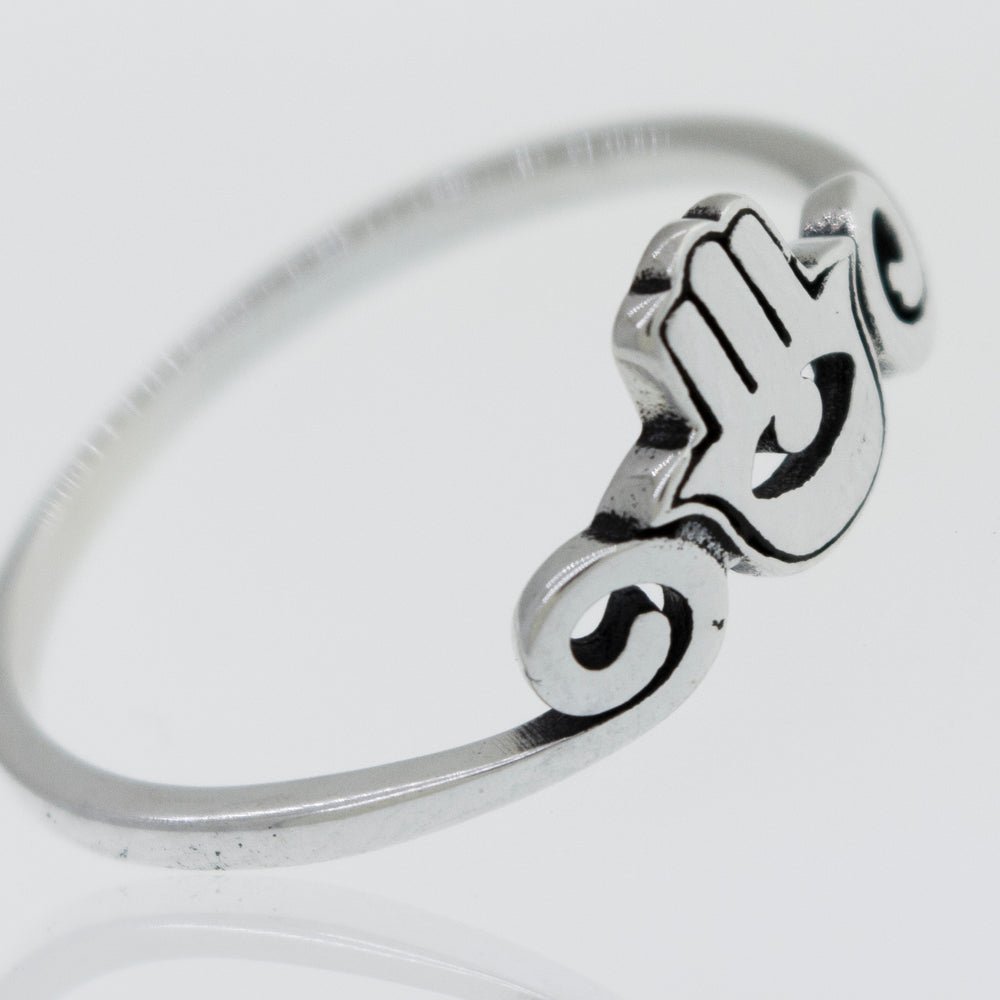 A Hamsa Ring made of sterling silver on a white surface.