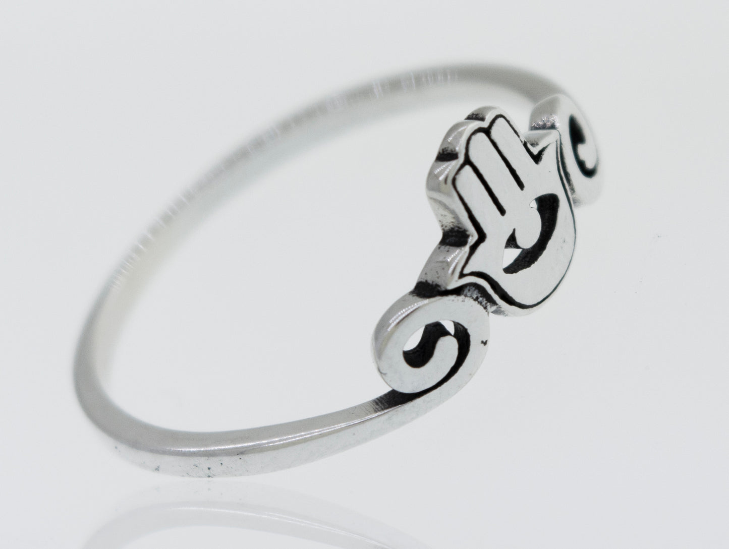 A Hamsa Ring made of sterling silver on a white surface.