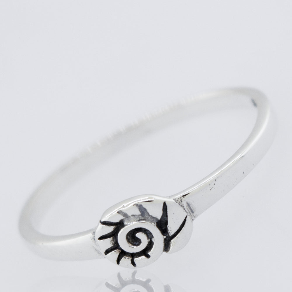 A Super Silver Shell Ring with a flower design.