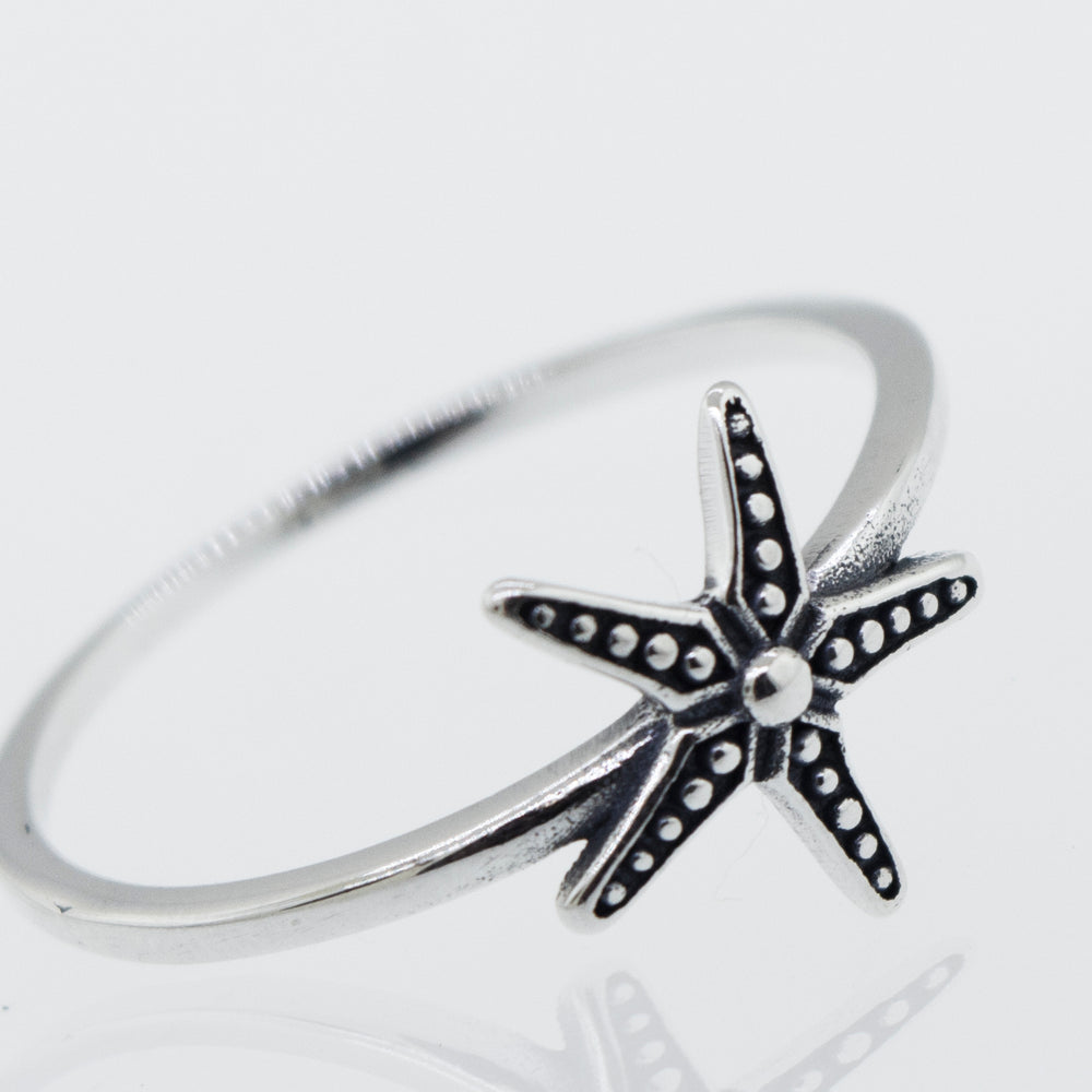 
                  
                    An oxidized Super Silver starfish ring on a white background.
                  
                