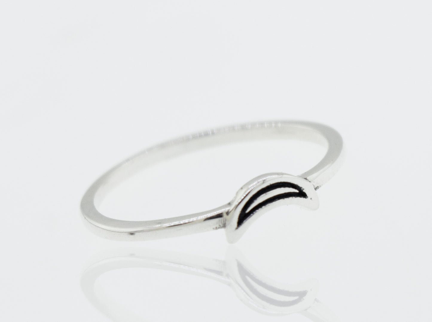 A Tiny Crescent Moon silver ring with a black and white design.