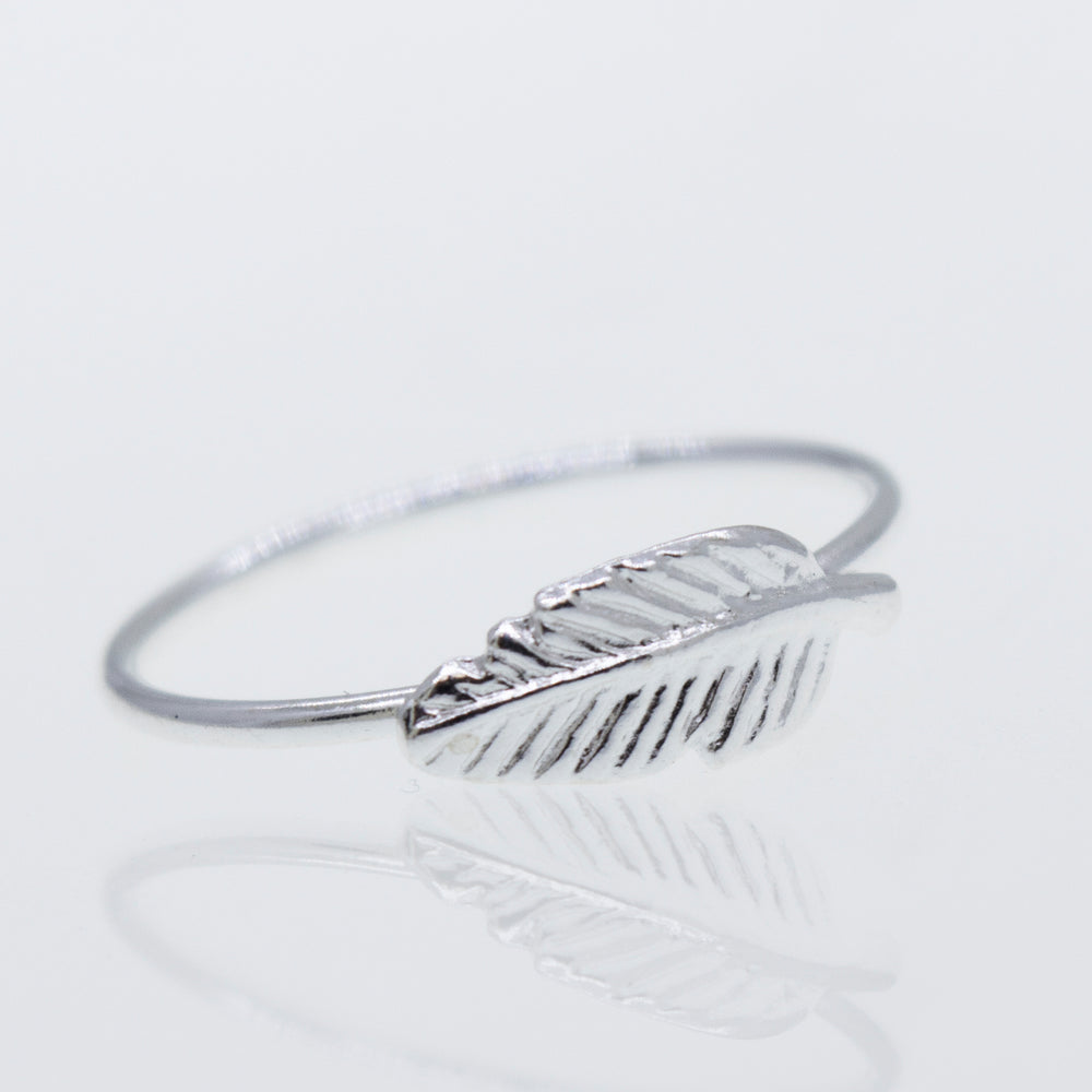 
                  
                    A Super Silver Silver Feather Ring on a white surface.
                  
                
