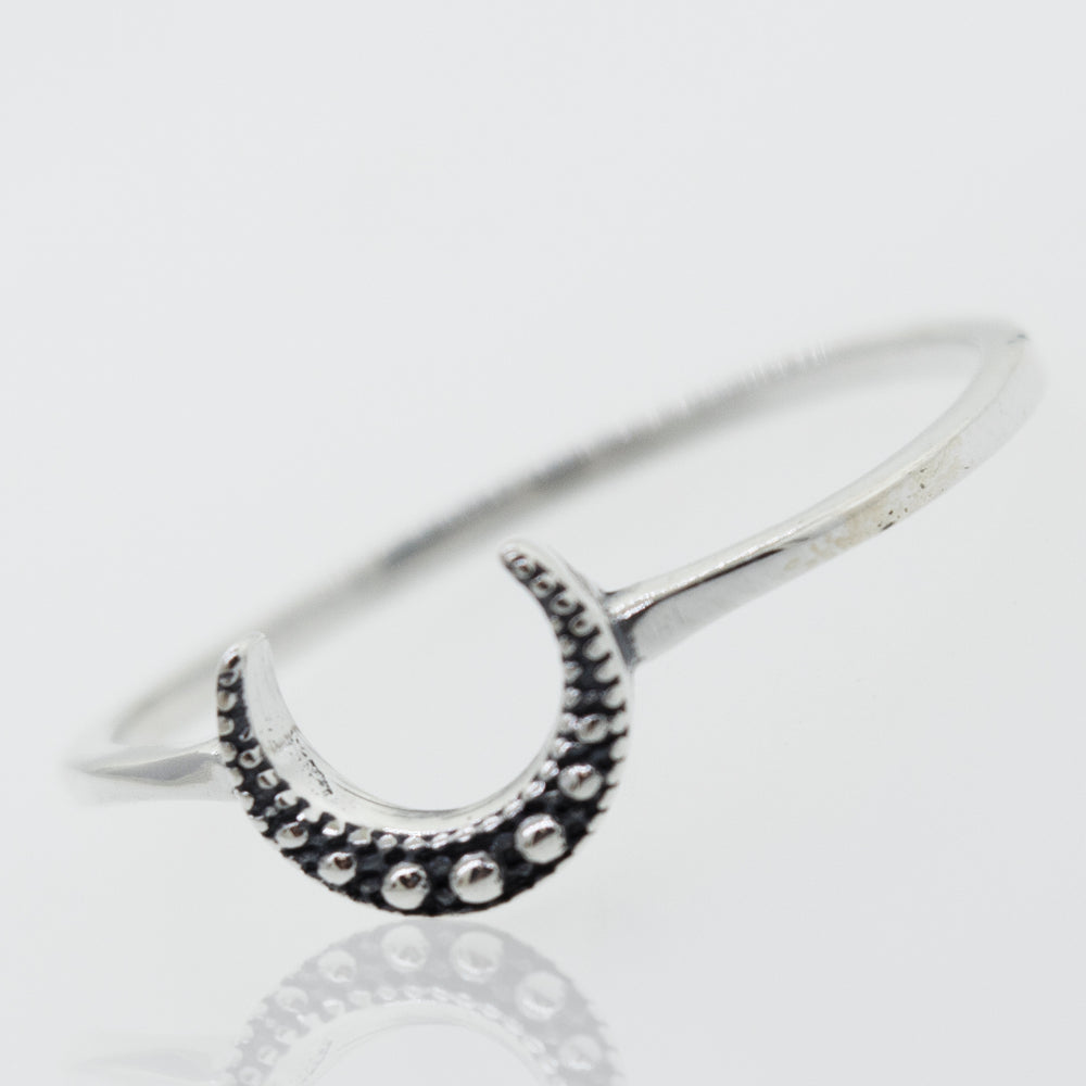A Super Silver Crescent Moon With Beads Design Silver Ring on a white surface.