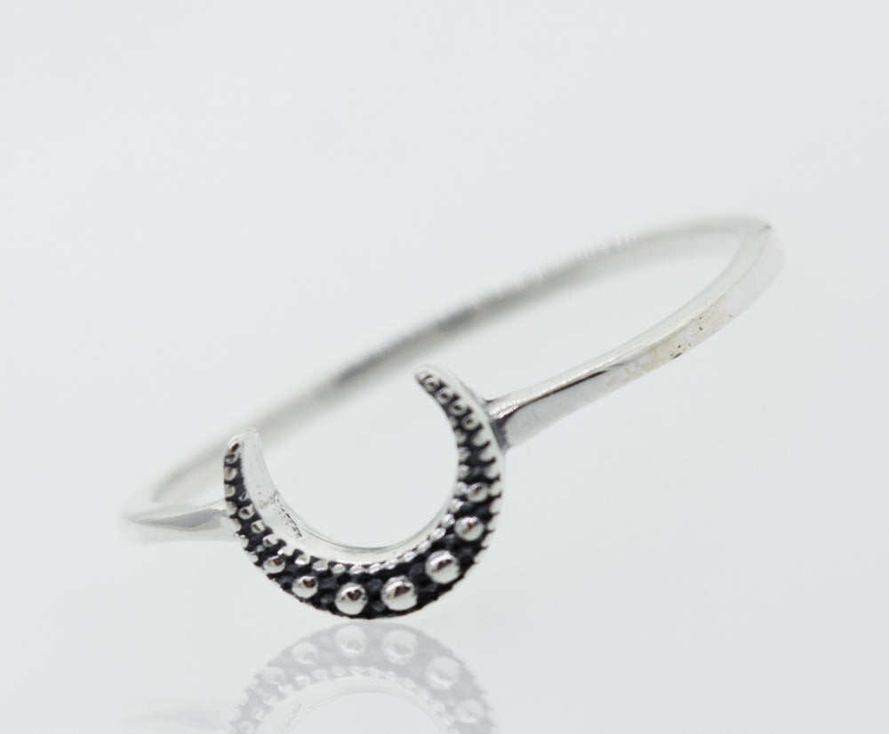 A Super Silver Crescent Moon With Beads Design Silver Ring on a white surface.