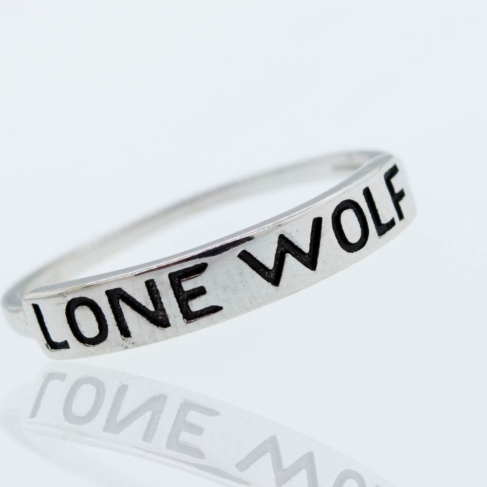 
                  
                    A Super Silver Sterling Silver Lone Wolf Ring with the word "lone wolf" engraved on it.
                  
                