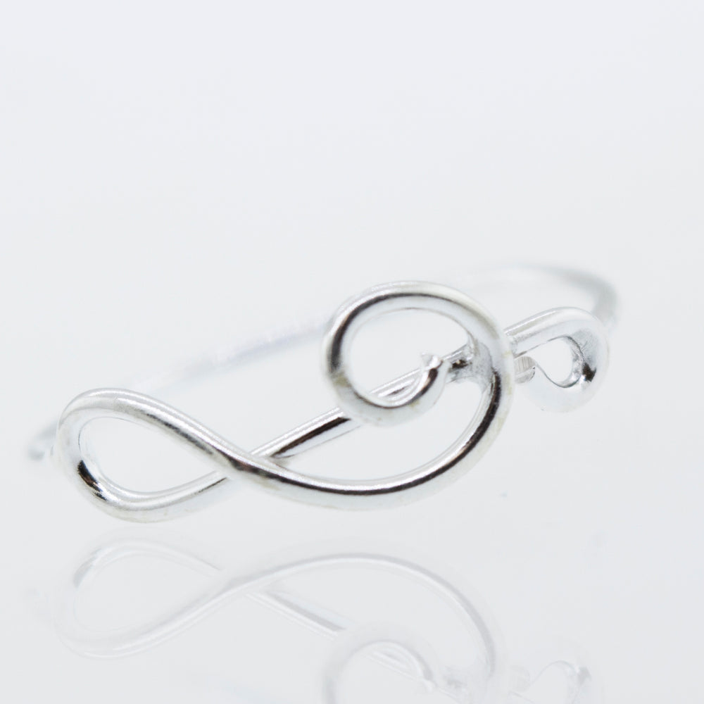 
                  
                    A Super Silver Horizontal Treble Clef Ring with a treble clef design on a high polish white surface.
                  
                