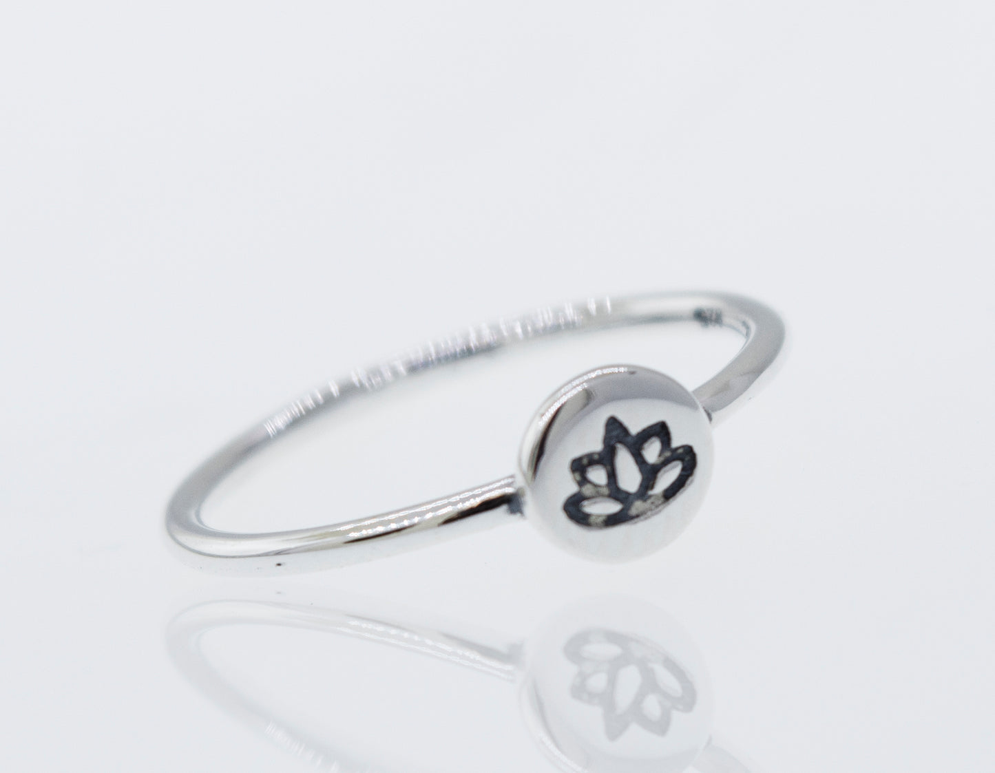 A modern stackable silver lotus ring with a minimalist lotus flower design.