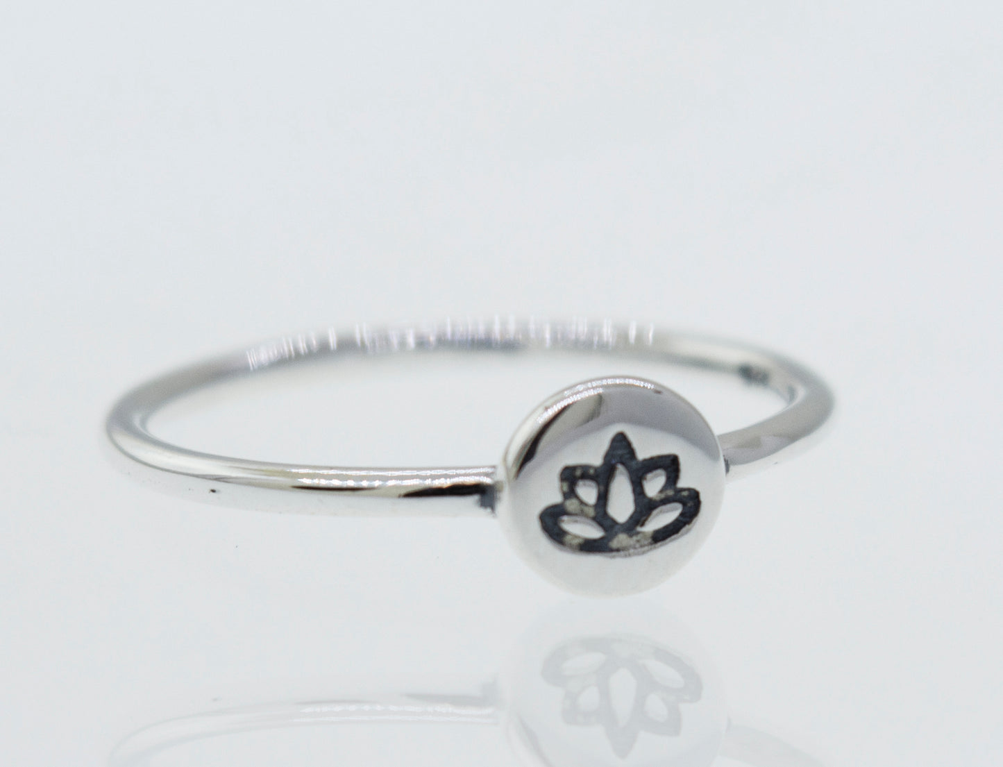 
                  
                    A minimalist Stackable Silver Lotus Ring featuring a lotus flower.
                  
                