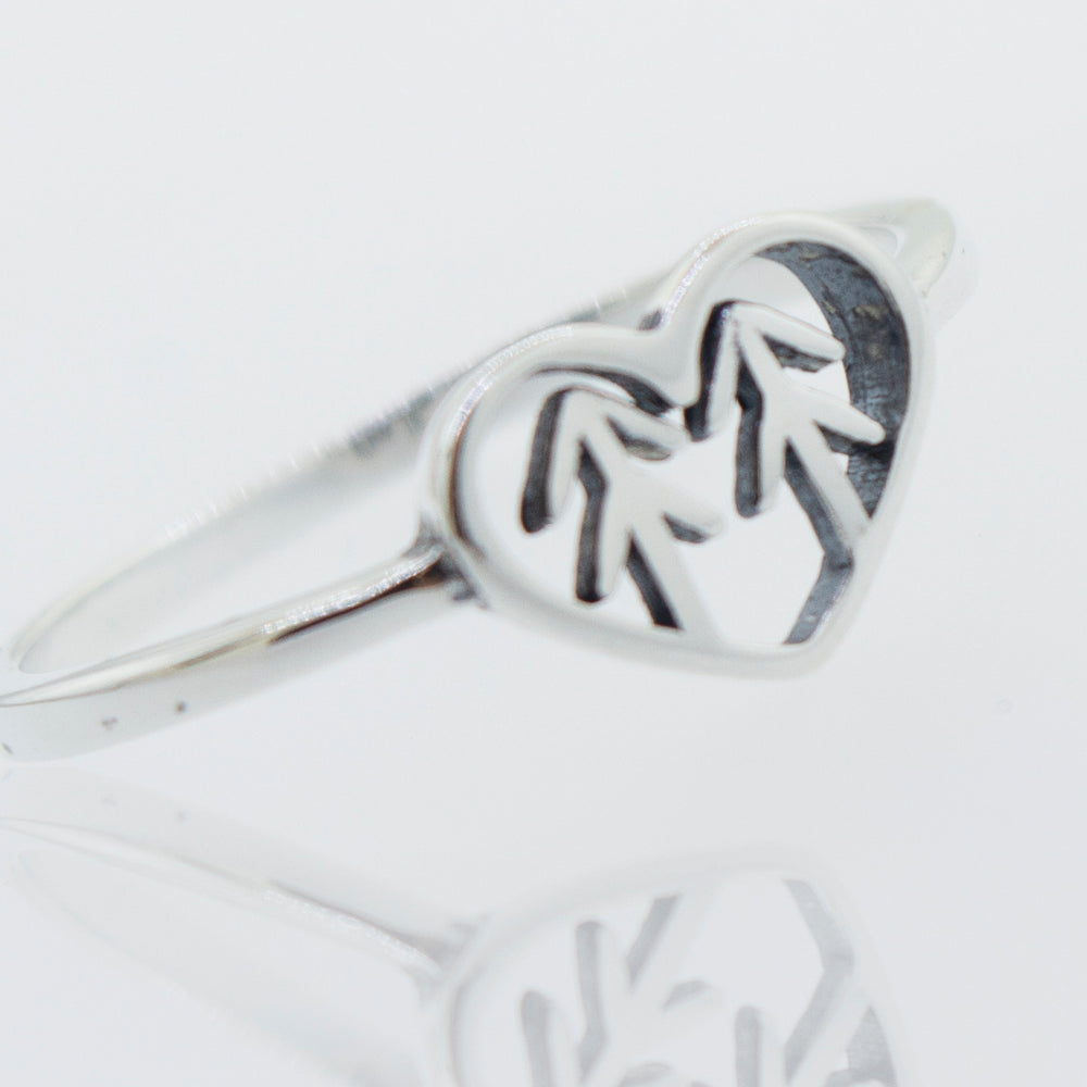 A Heart With Trees Silver Ring with a pine tree in the middle, representing love and nature.