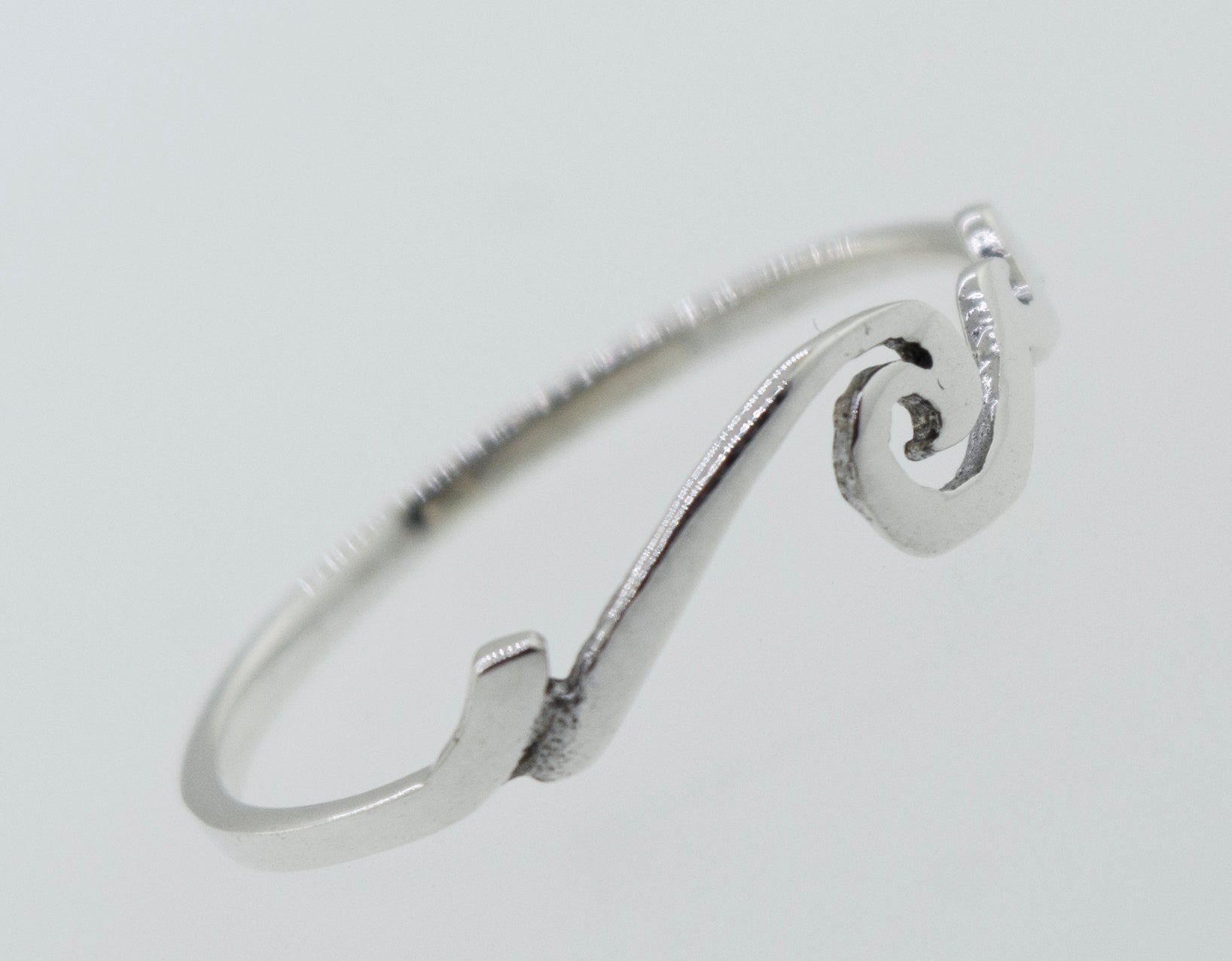 A minimalistic Wave Ring with a wave design, perfect for stacking and reminiscent of the coastal beauty of Santa Cruz.